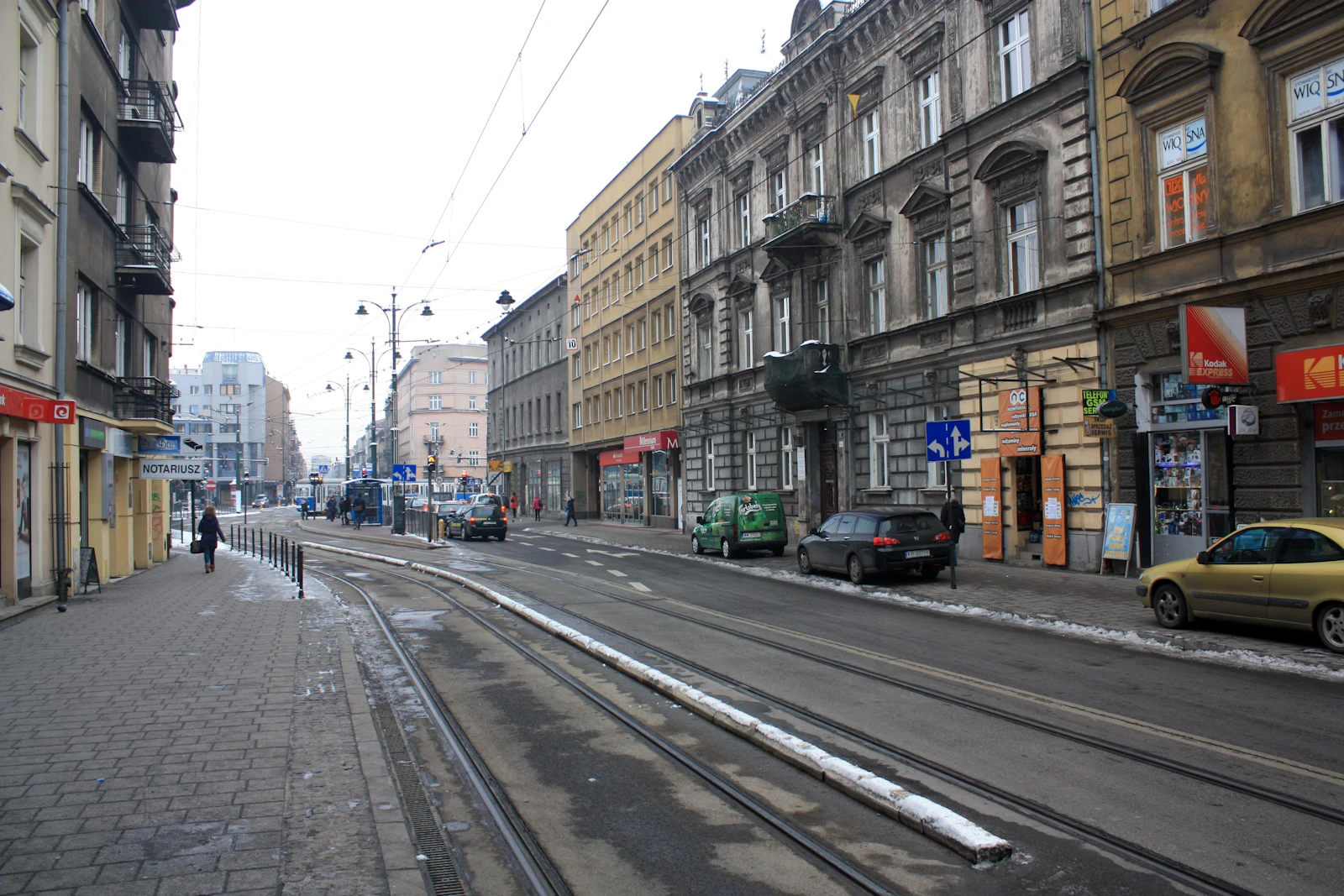 Tram tracks and parked cars share a central Krakow street