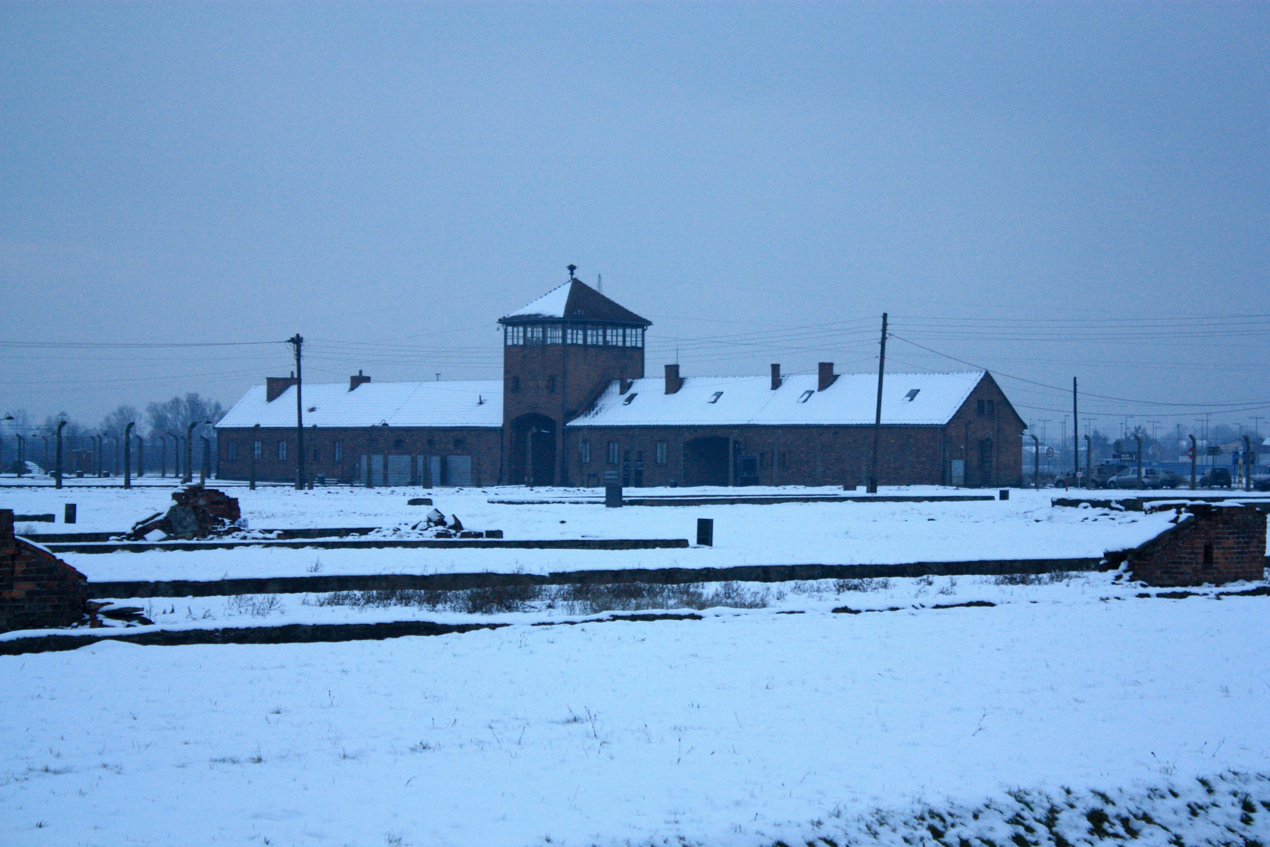 A snow covered field with a building in the background