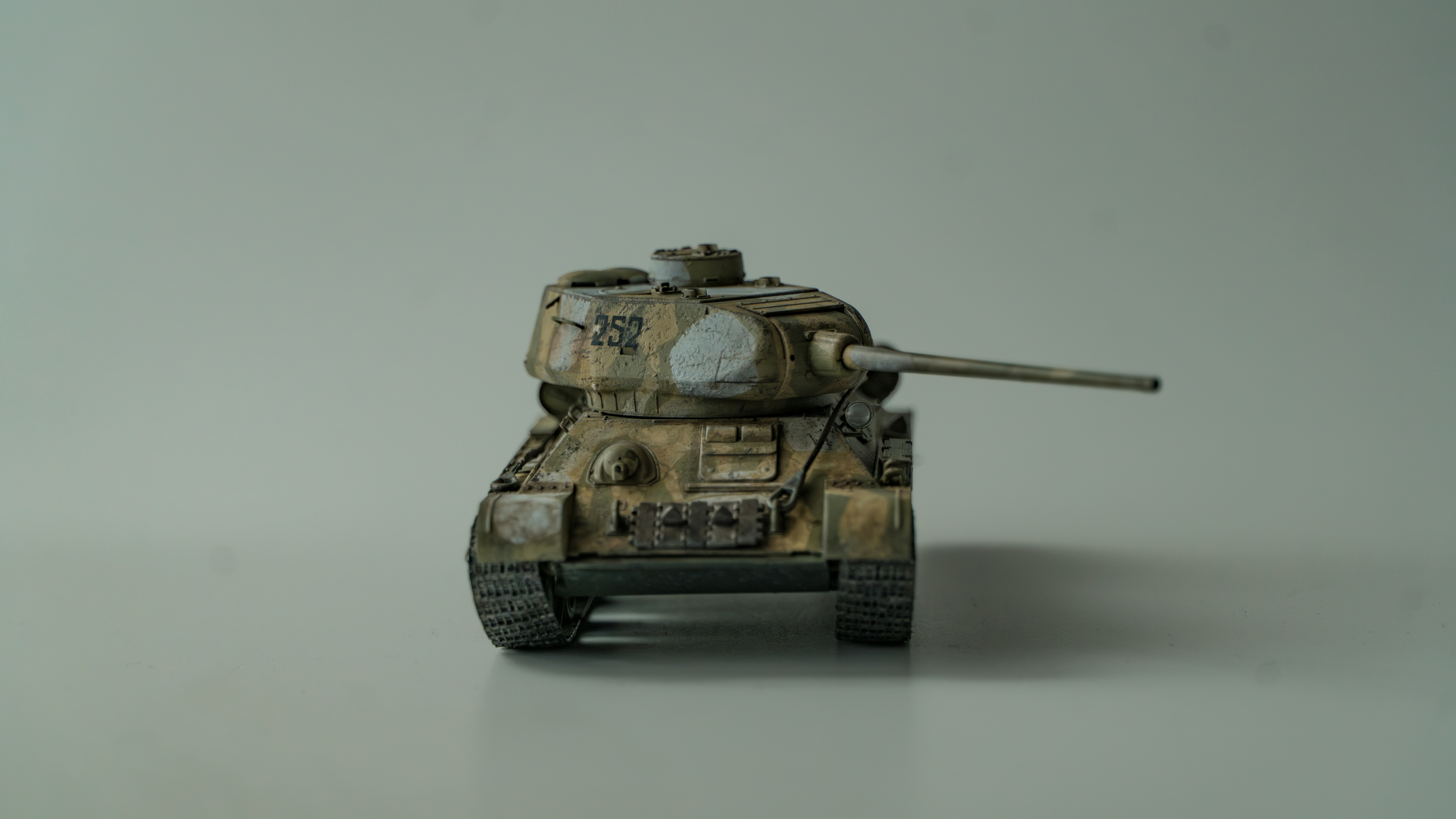 A small toy tank sitting on top of a table