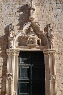 A large stone building with a black door