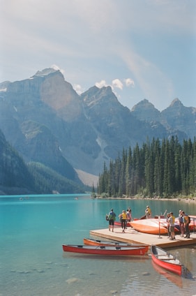 A group of people standing on a dock next to boats