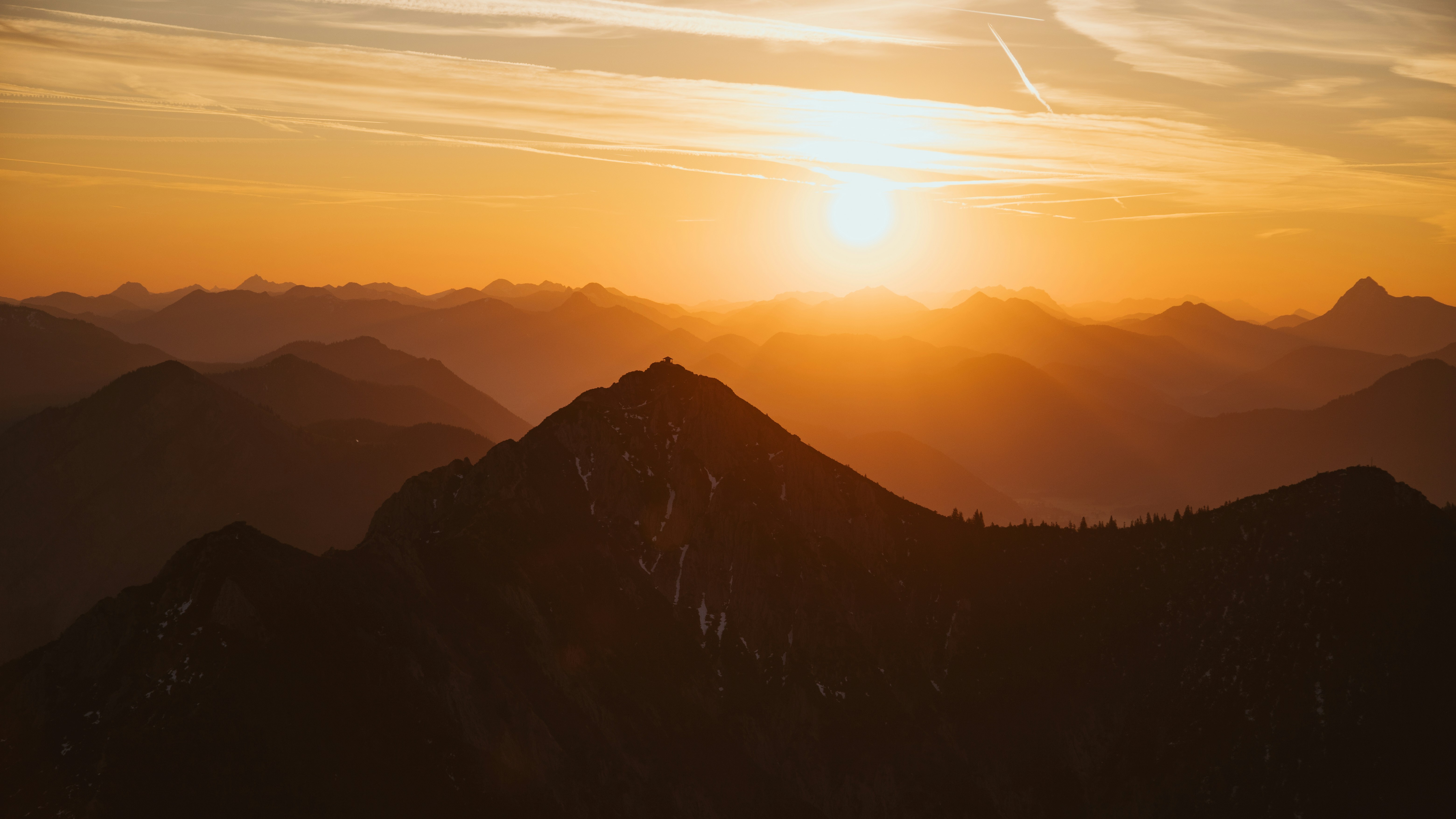 The sun is setting over a mountain range