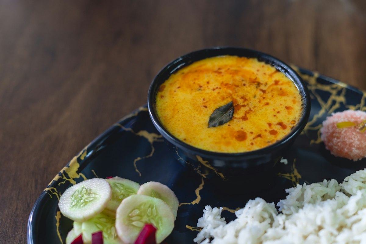 Dal makhani black lentil curry in a bowl topped with cream and butter
