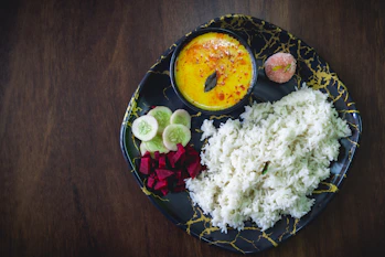 A black plate topped with different types of food