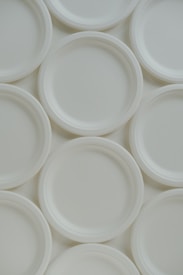 A group of white plates sitting on top of each other