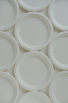 A group of white plates sitting on top of each other