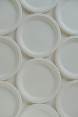 A group of white plates sitting on top of each other