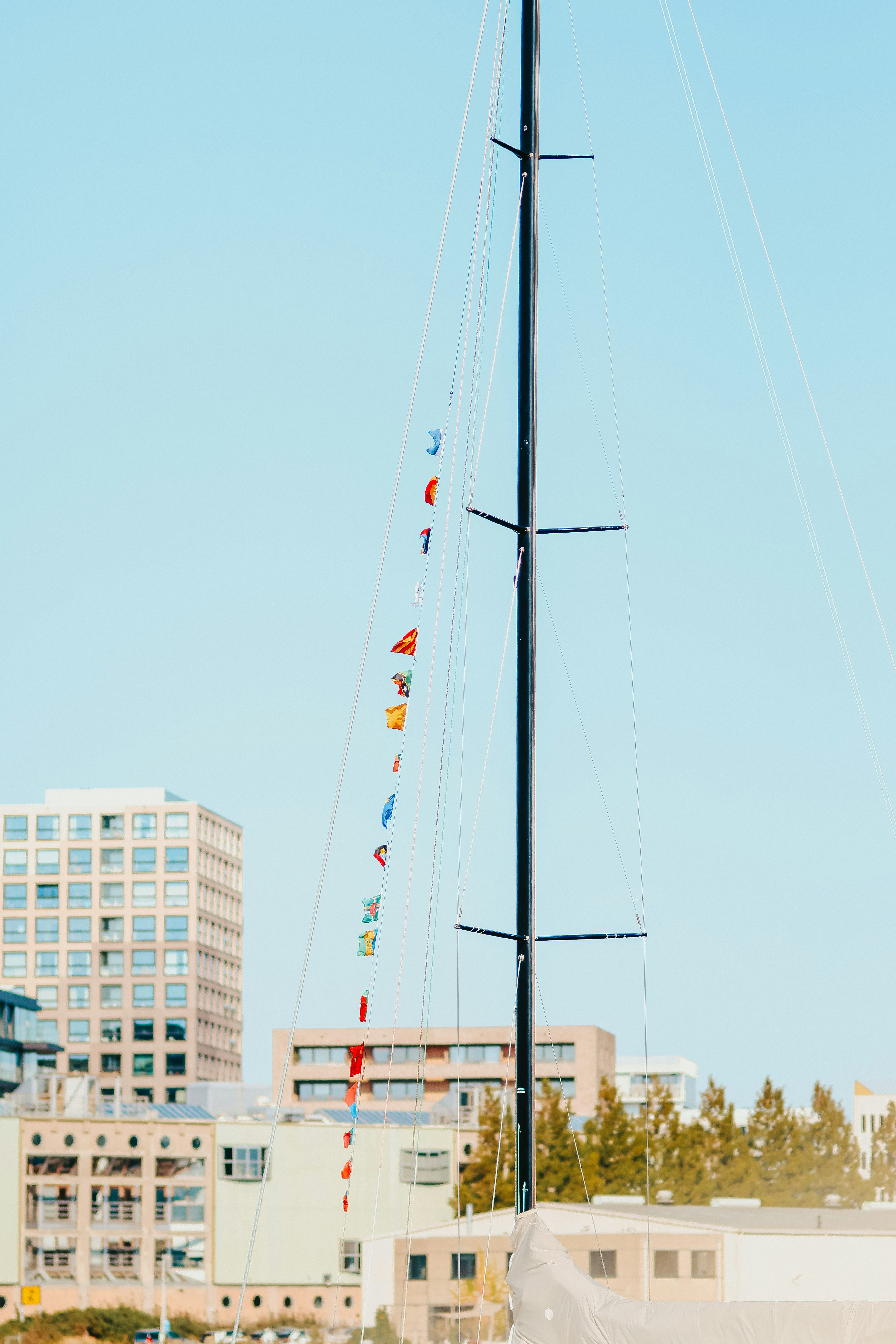 A sailboat in the water with a city in the background