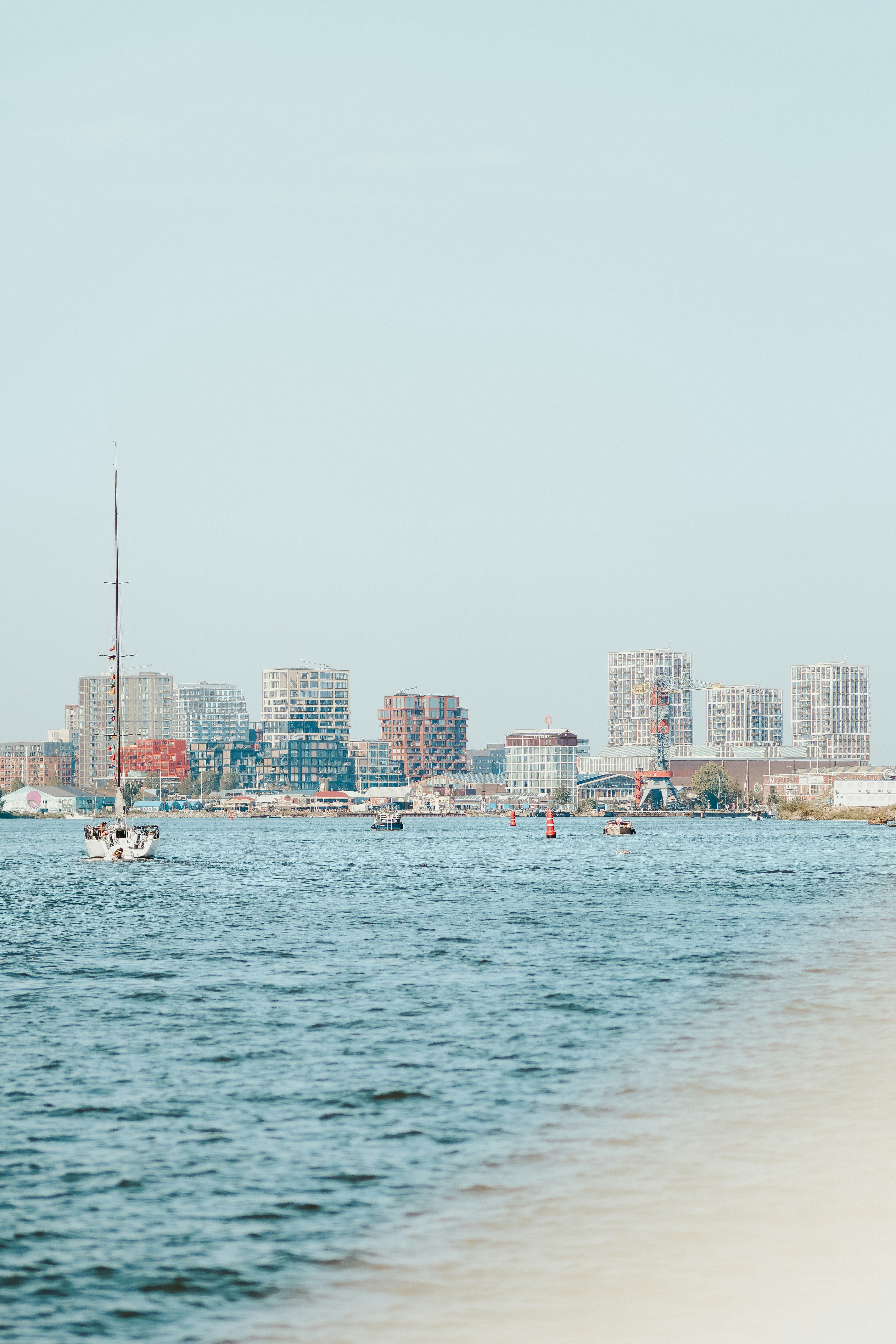 A body of water with a city in the background