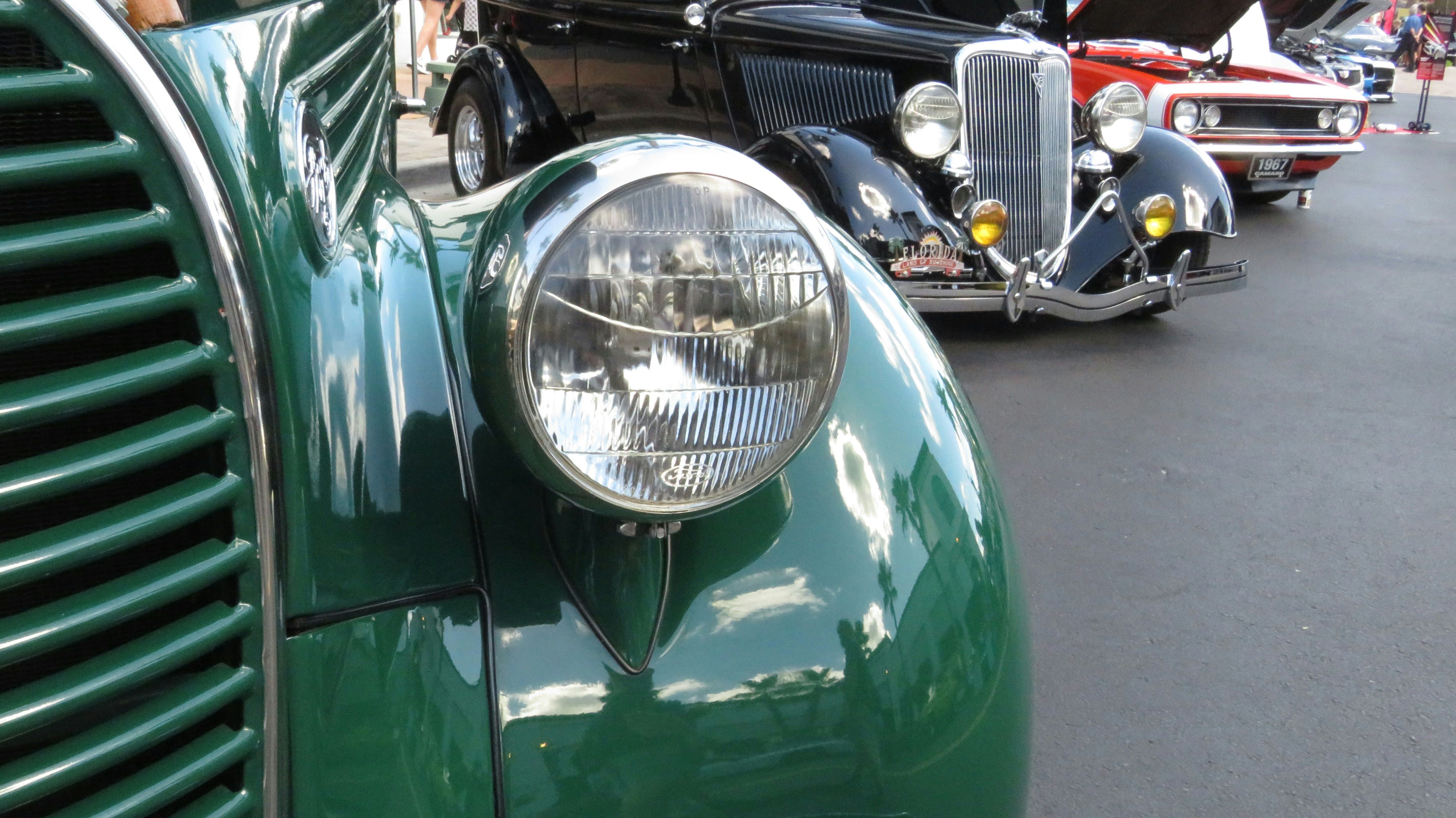 A row of classic cars parked next to each other