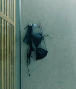 A black umbrella is hanging on the wall