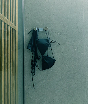 A black umbrella is hanging on the wall