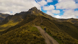 A man riding a bike down a dirt road