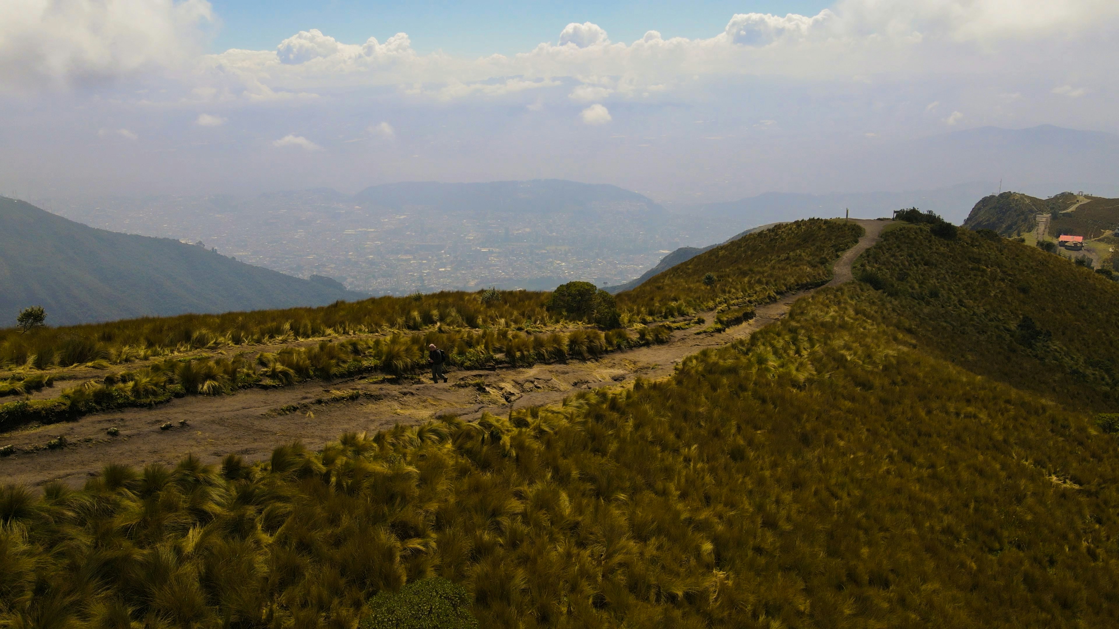 An aerial view of a dirt road in the mountains, 