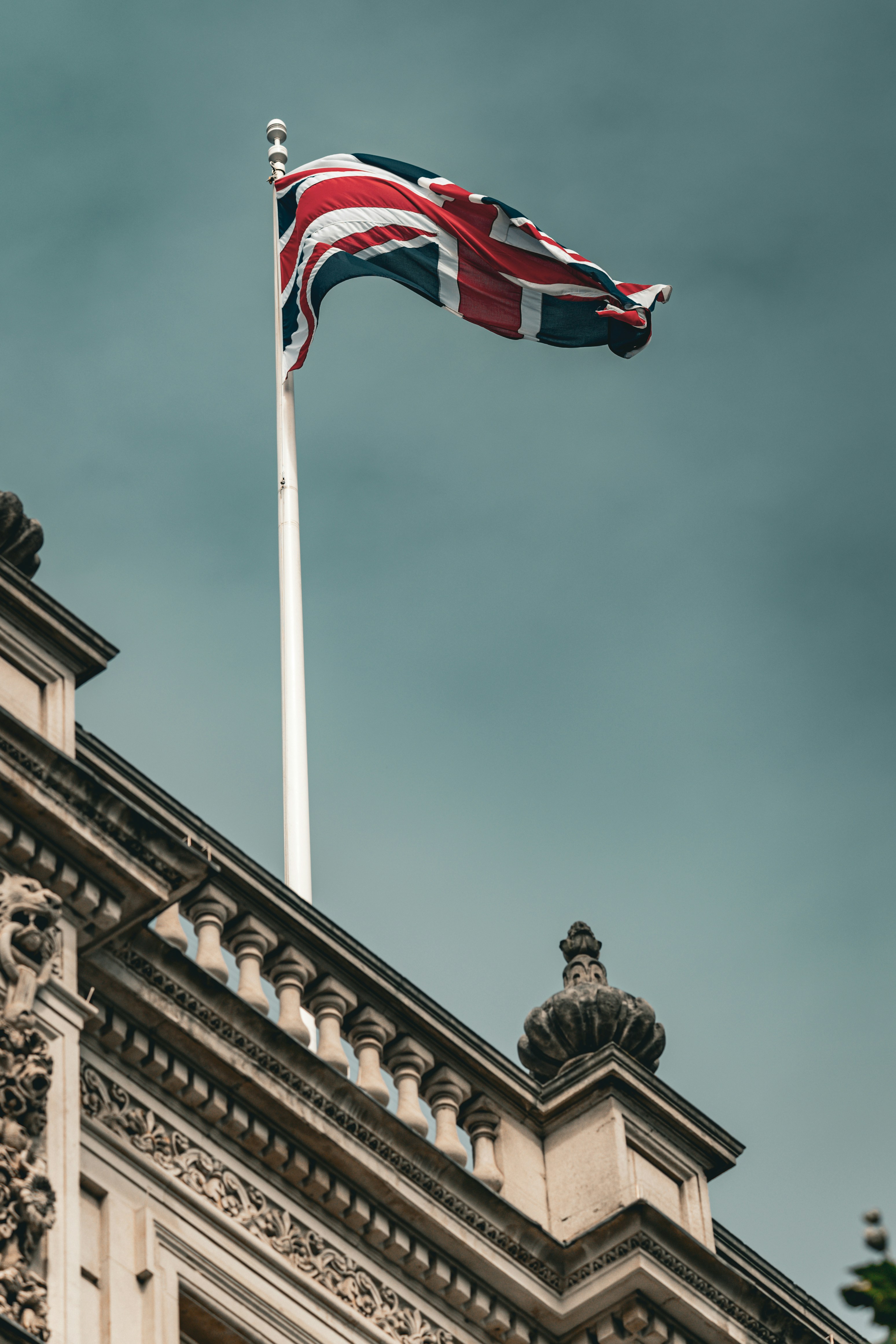 A flag flying on top of a tall building