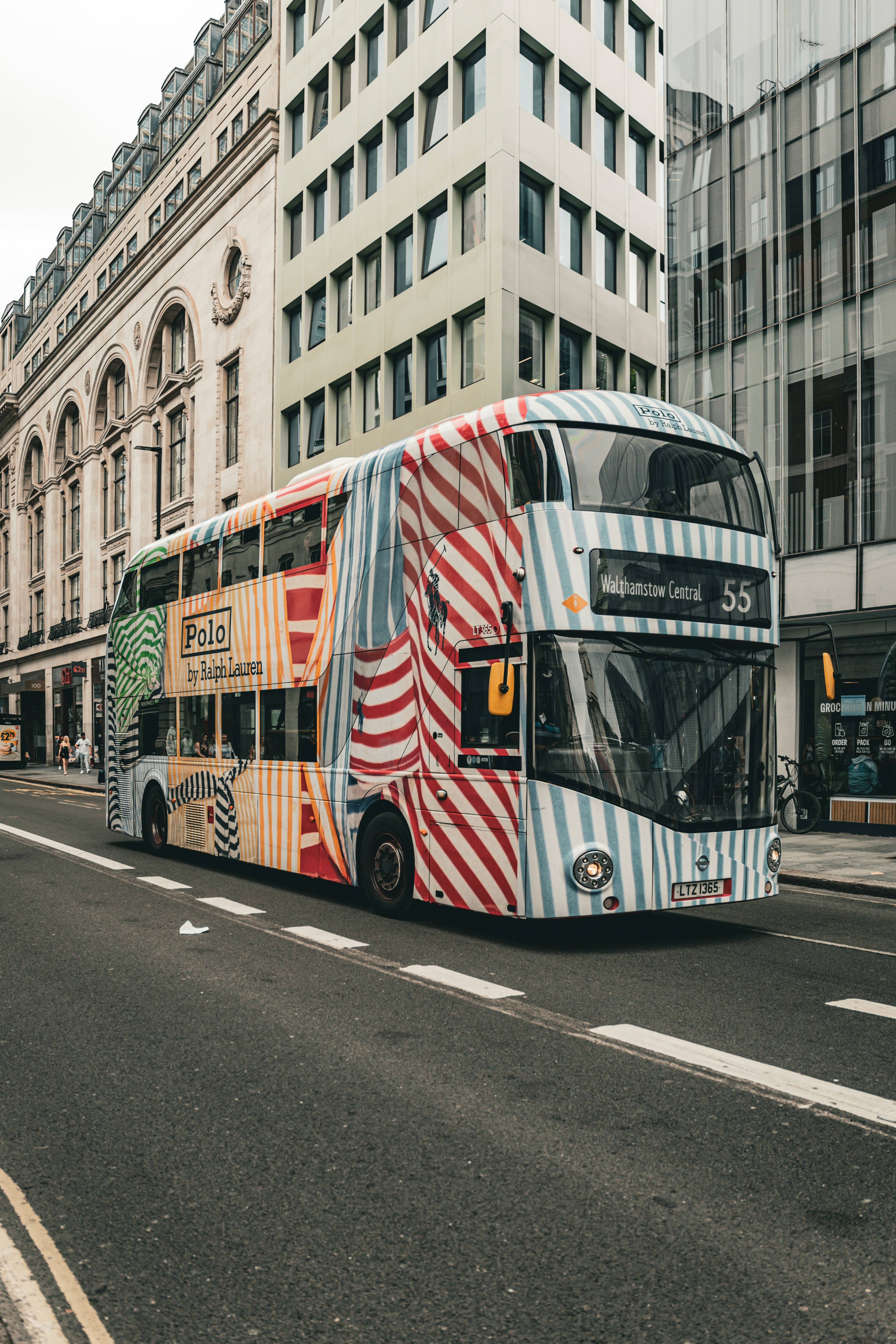 A double decker bus driving down a city street