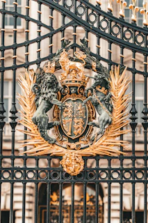 A black iron gate with a coat of arms on it