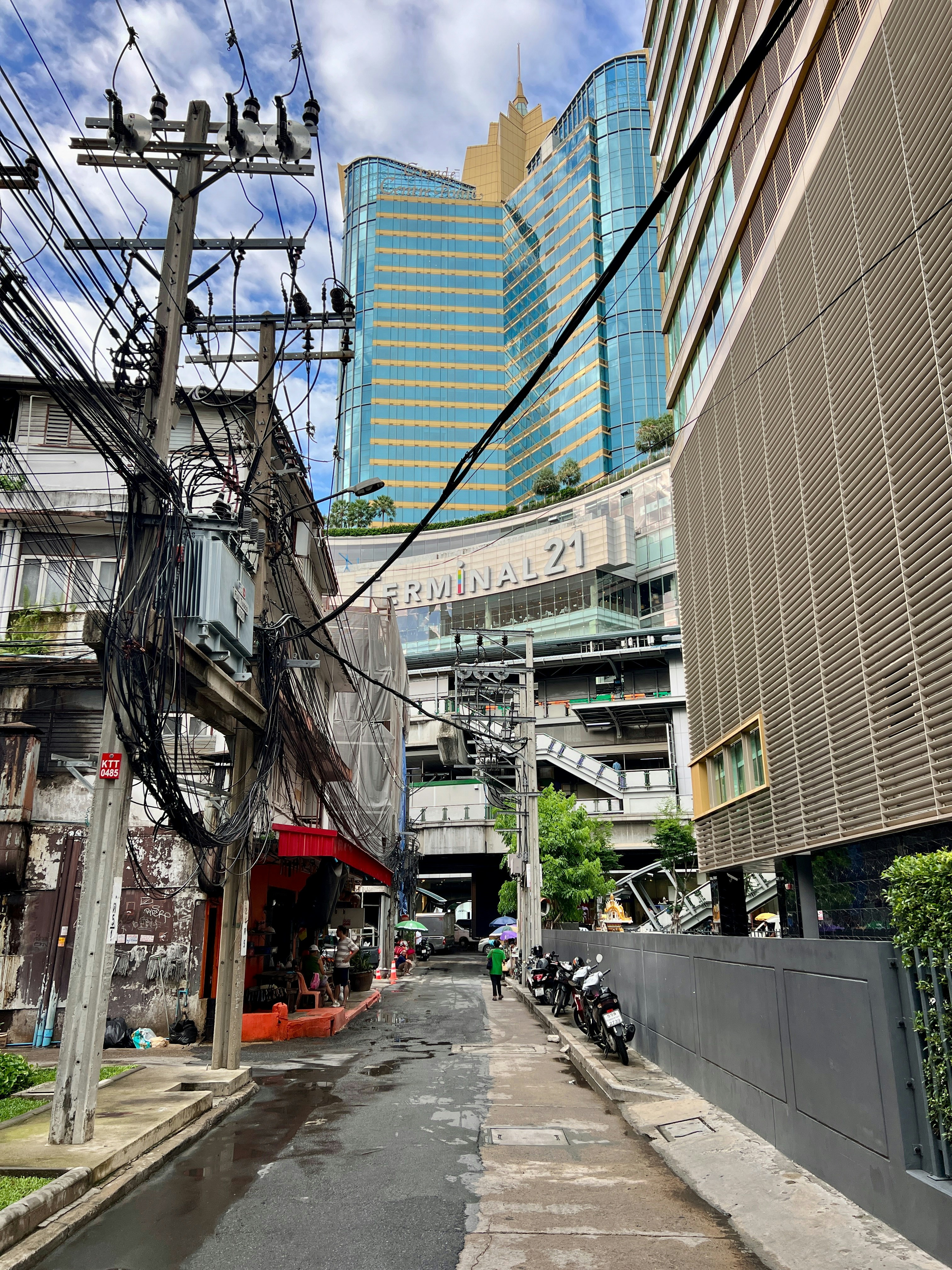 A city street with lots of power lines above it