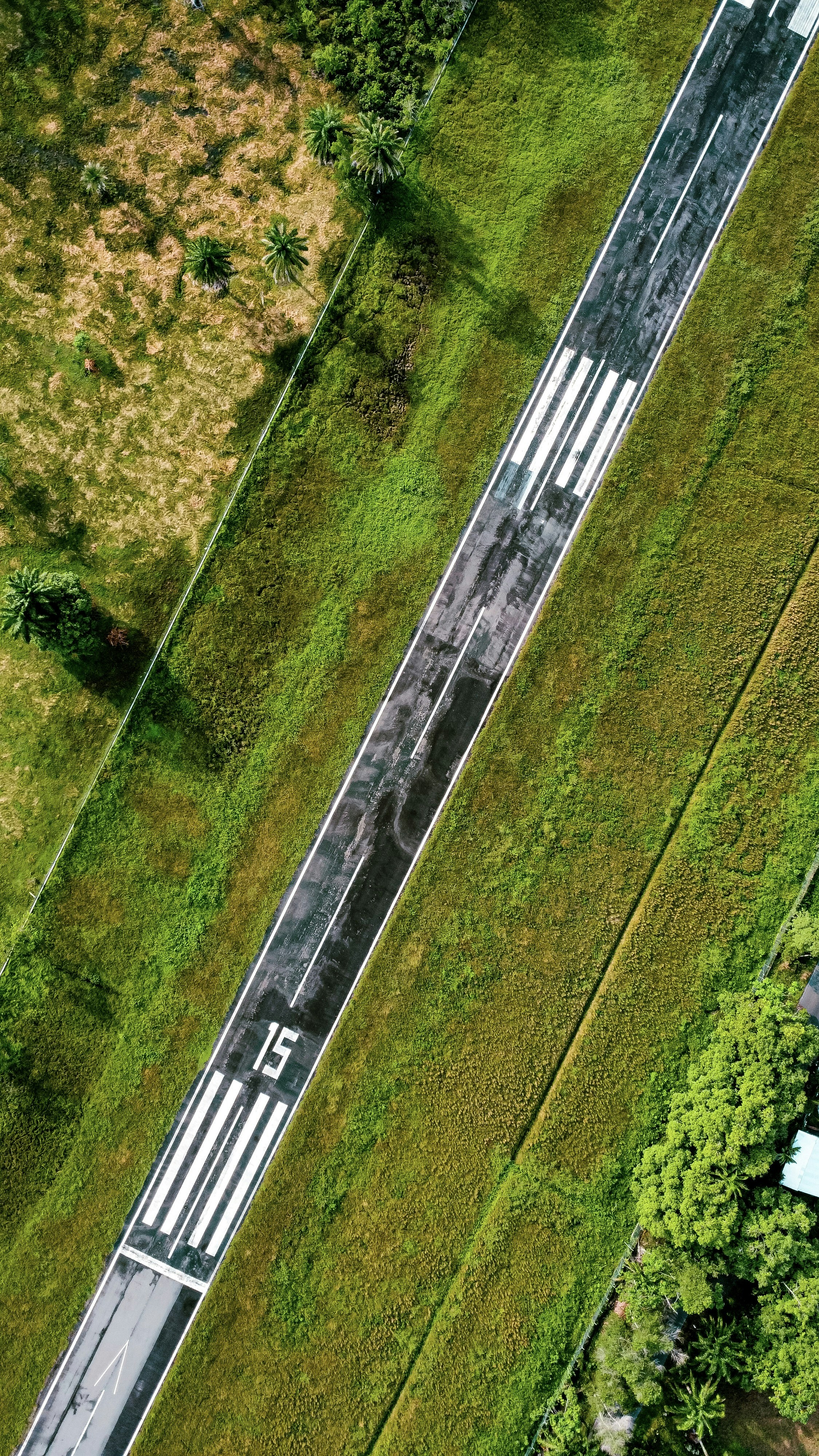 An aerial view of a train track in the middle of a field