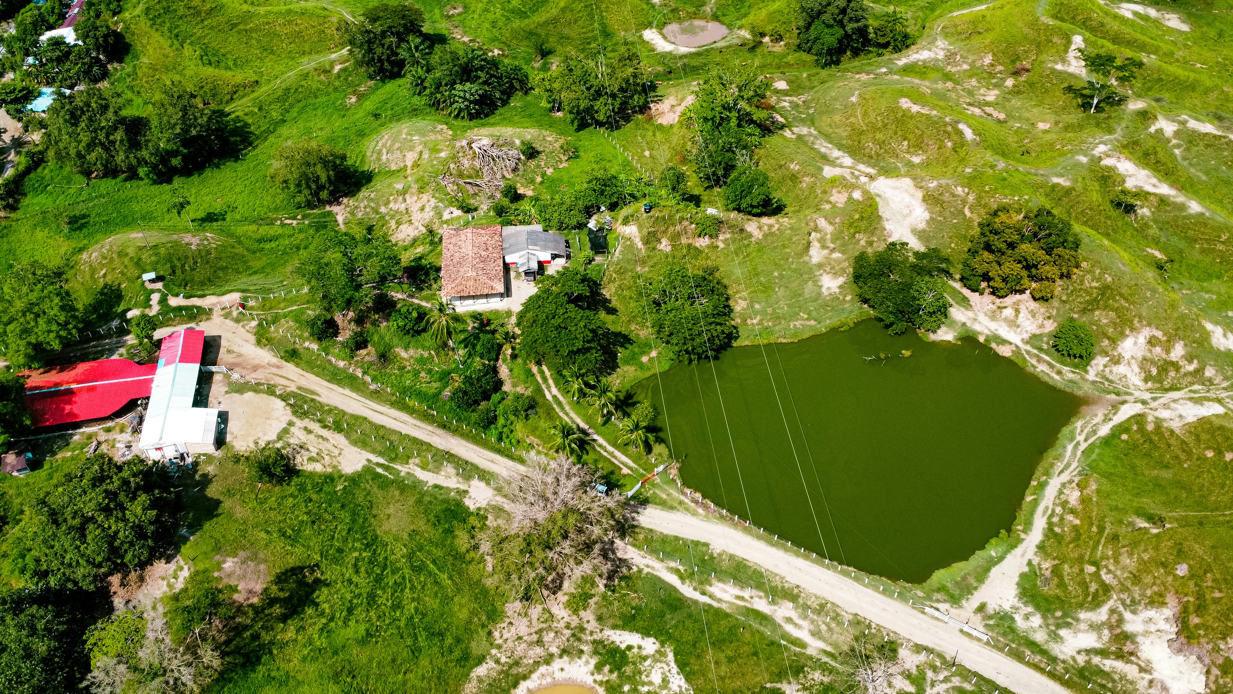 Aerial view of large Australian farm with green fields and agricultural buildings