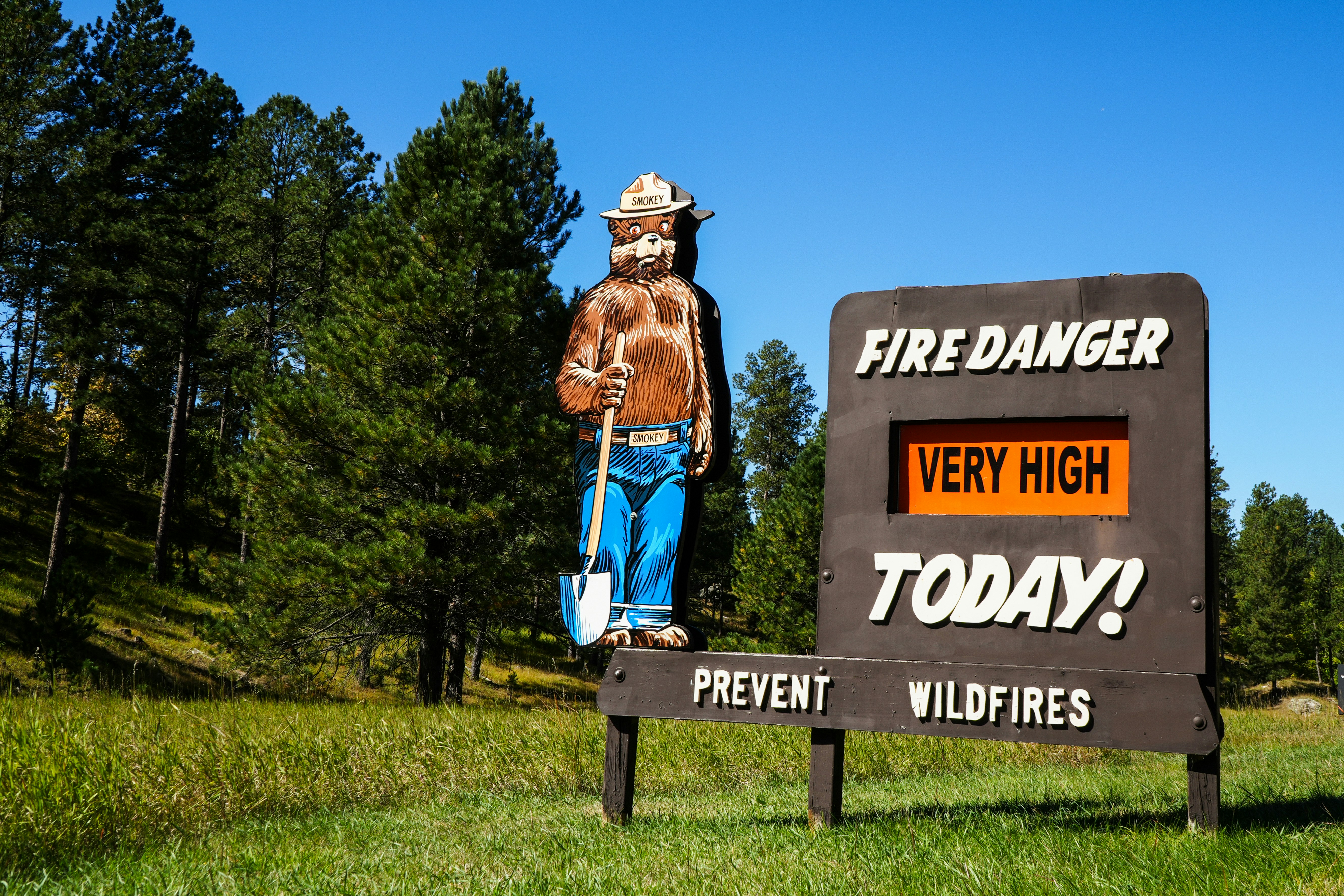 A sign with a man standing on top of it