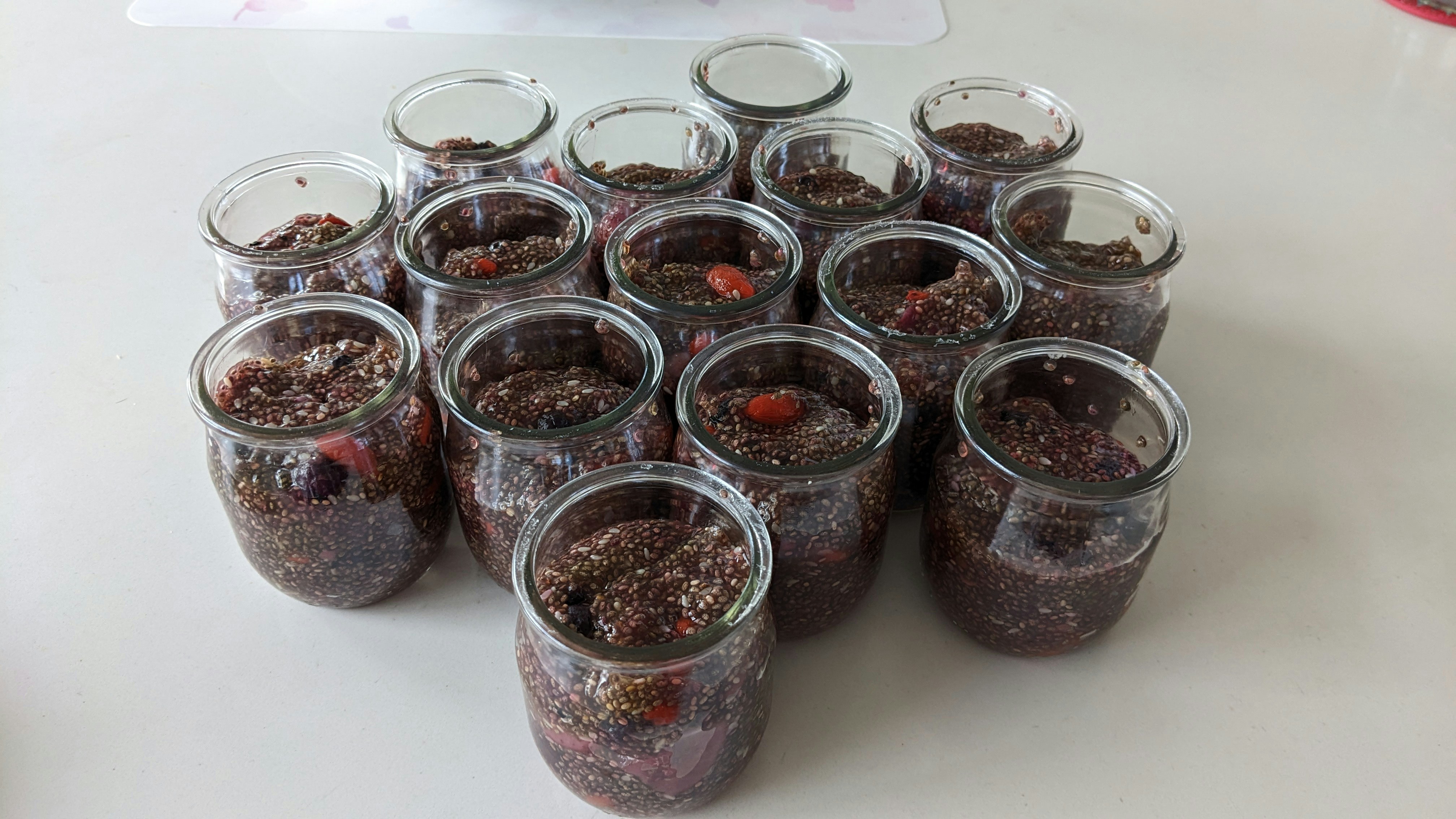 A table topped with lots of jars filled with food