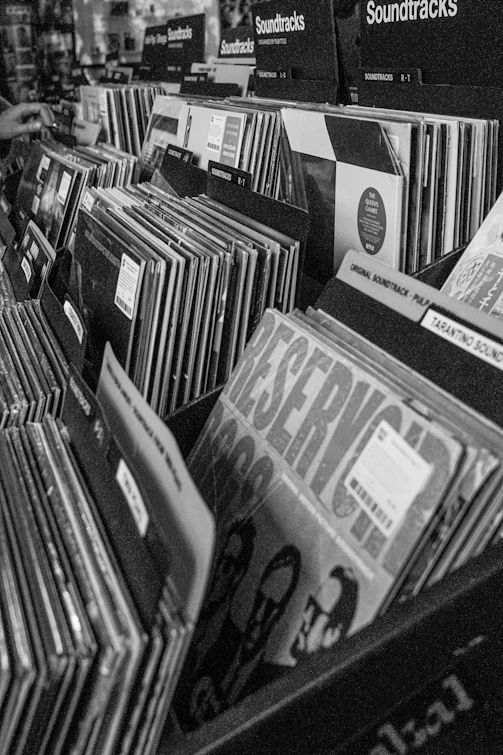 A man is looking at records in a record store