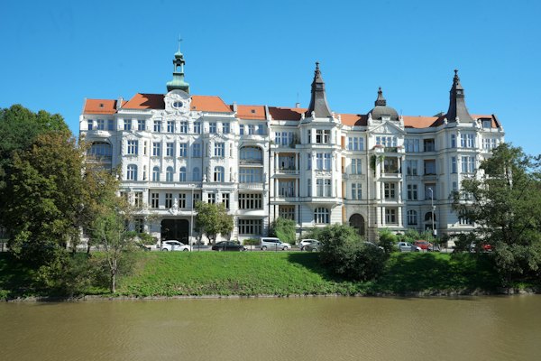 A large white building sitting on the side of a river — Wrocław, Poland