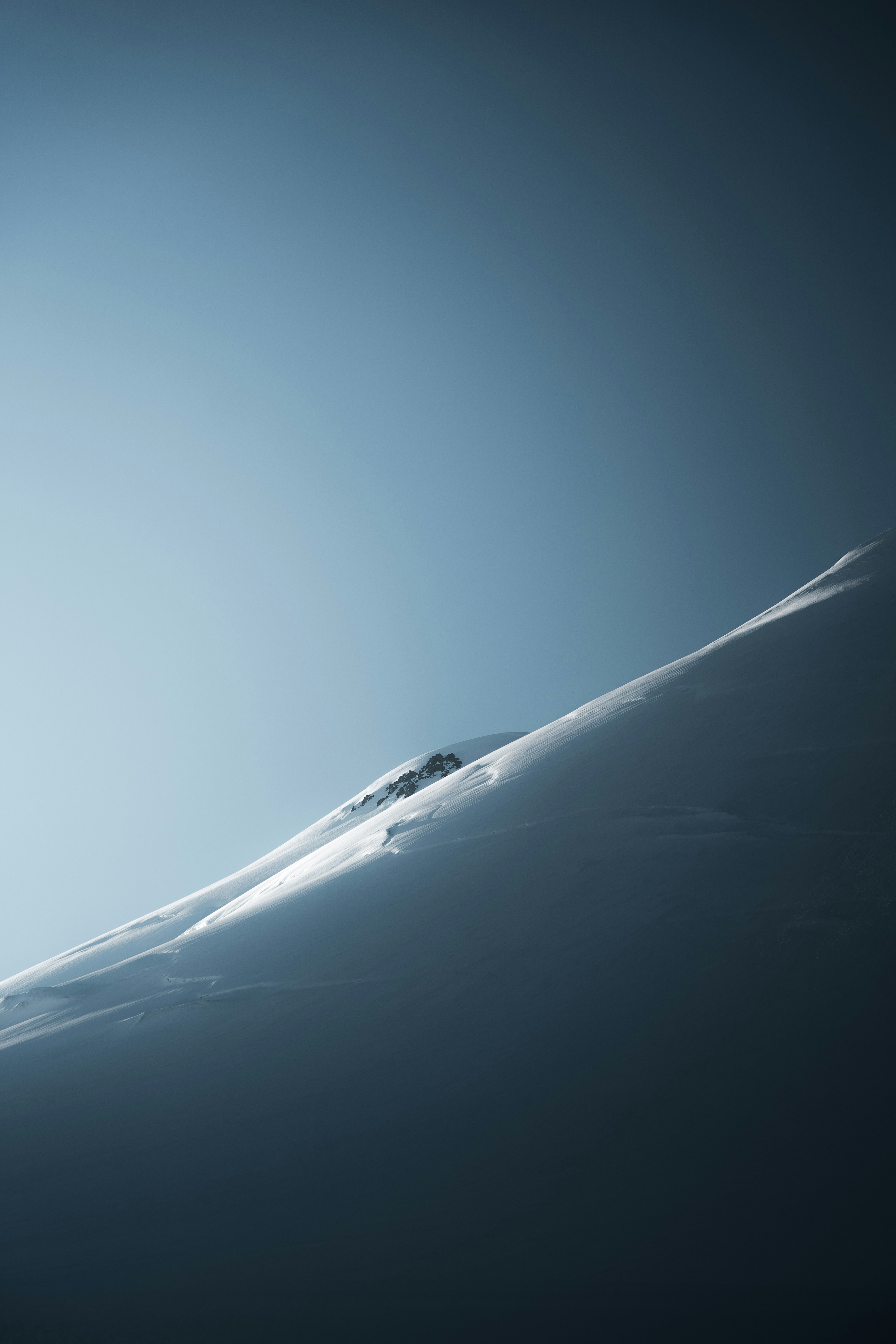 A person skiing down a snow covered slope