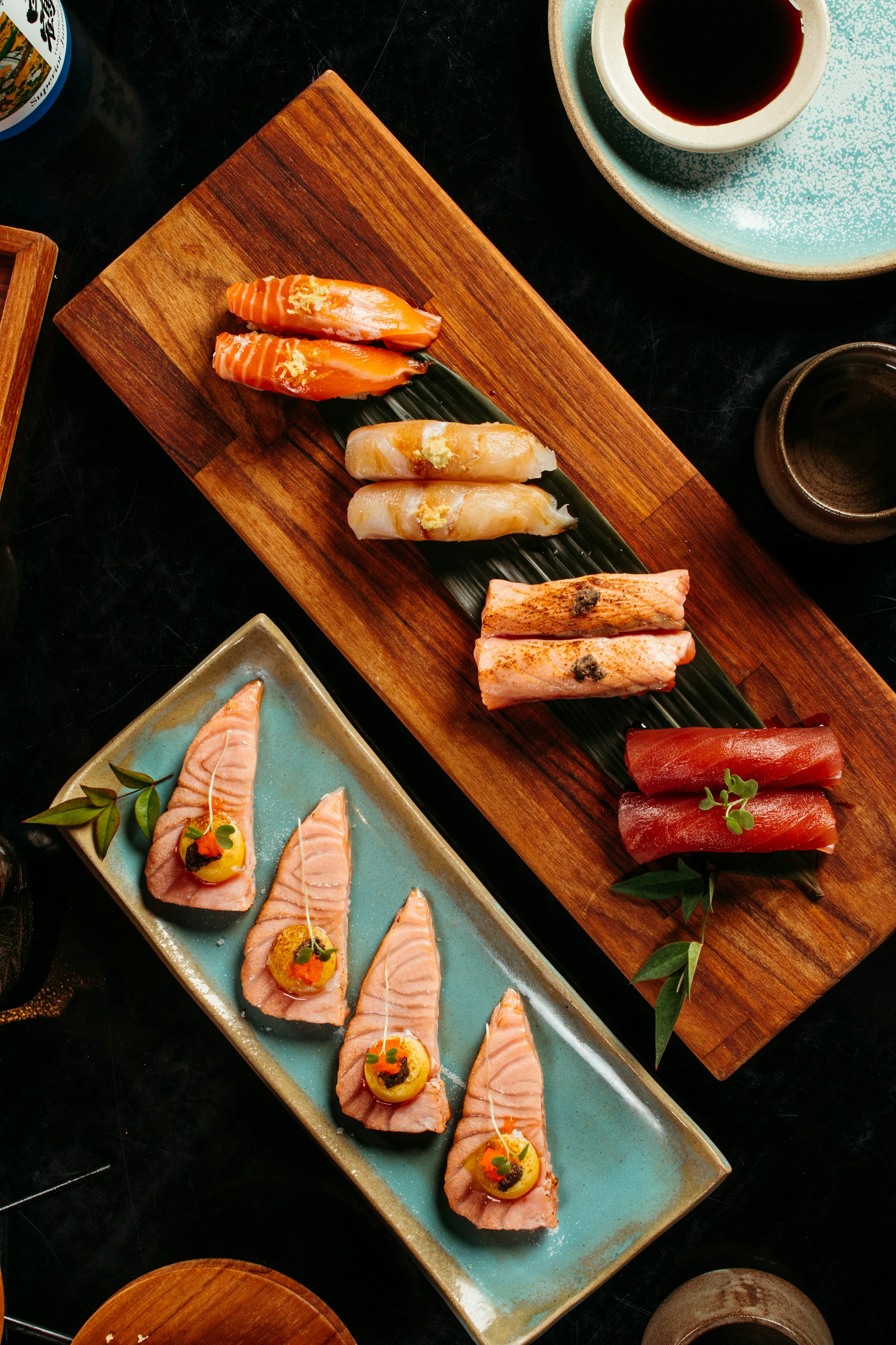A table topped with plates of sushi and chopsticks