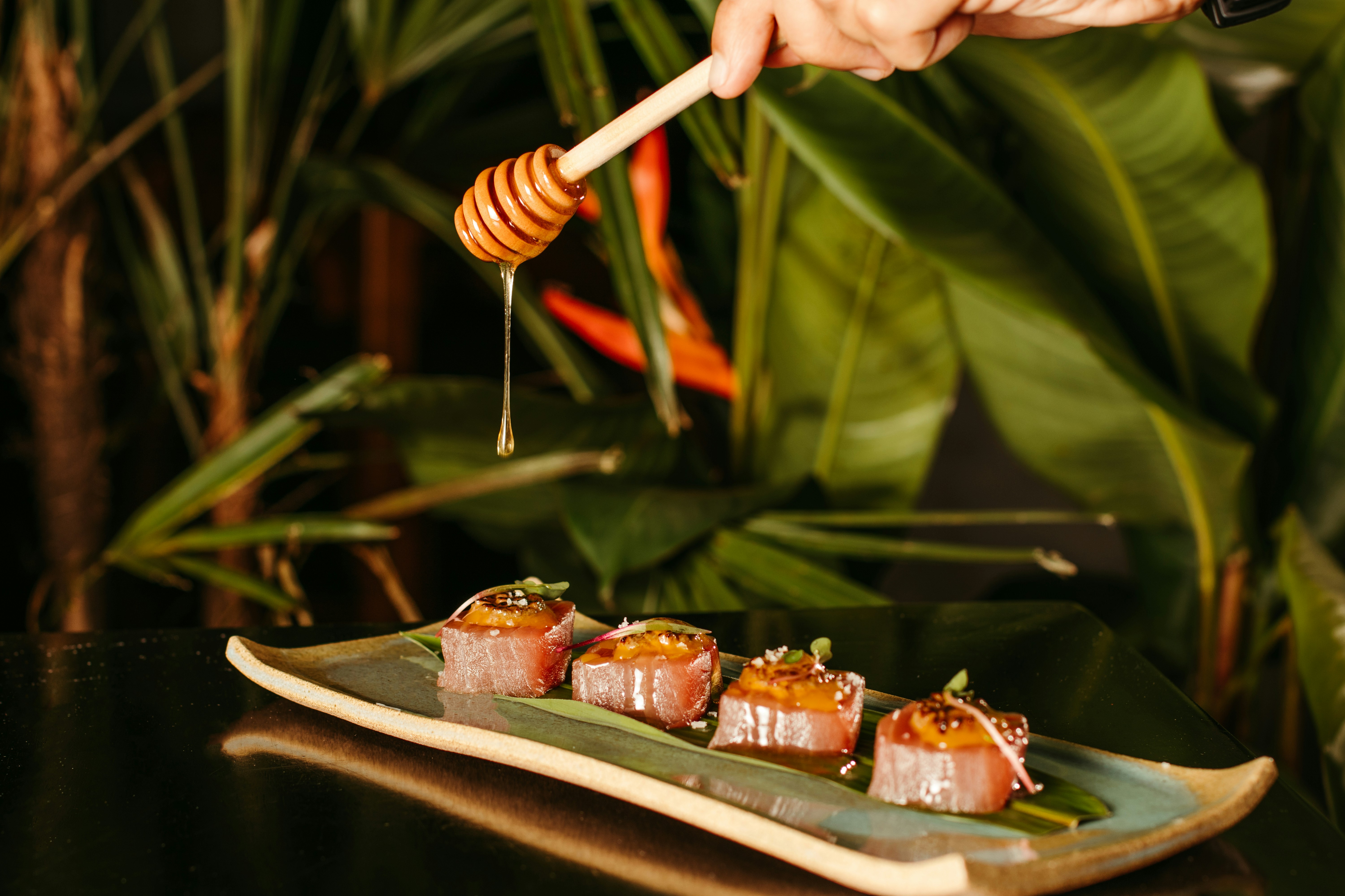 Sushi rolls on a plate with honey drizzle