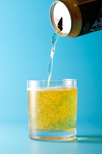 A bottle of beer being poured into a glass