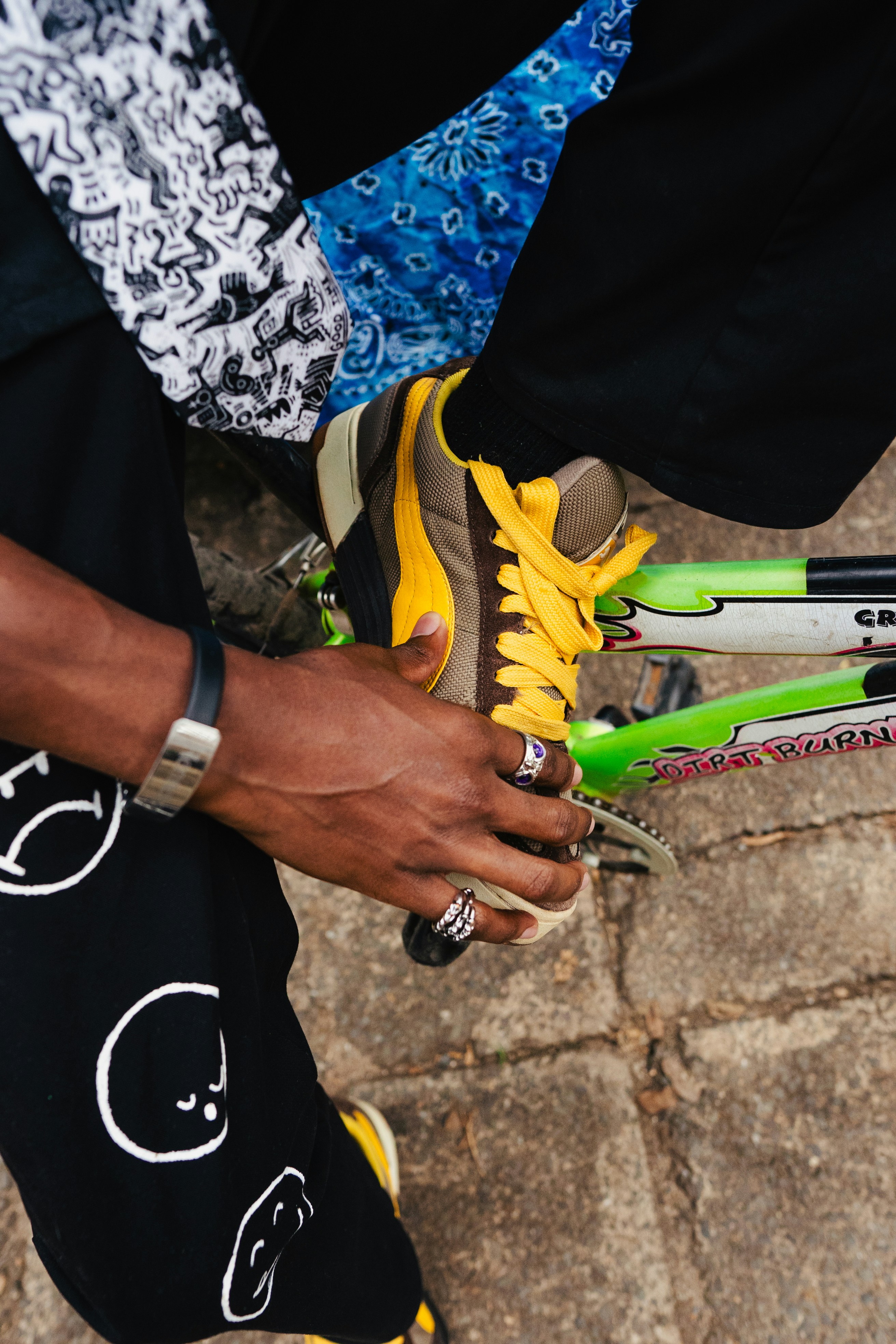 A close up of a person holding a pair of tennis rackets