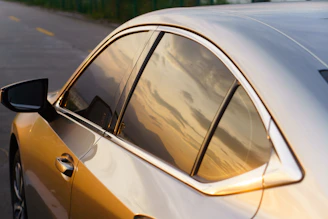 A silver car parked on the side of the road