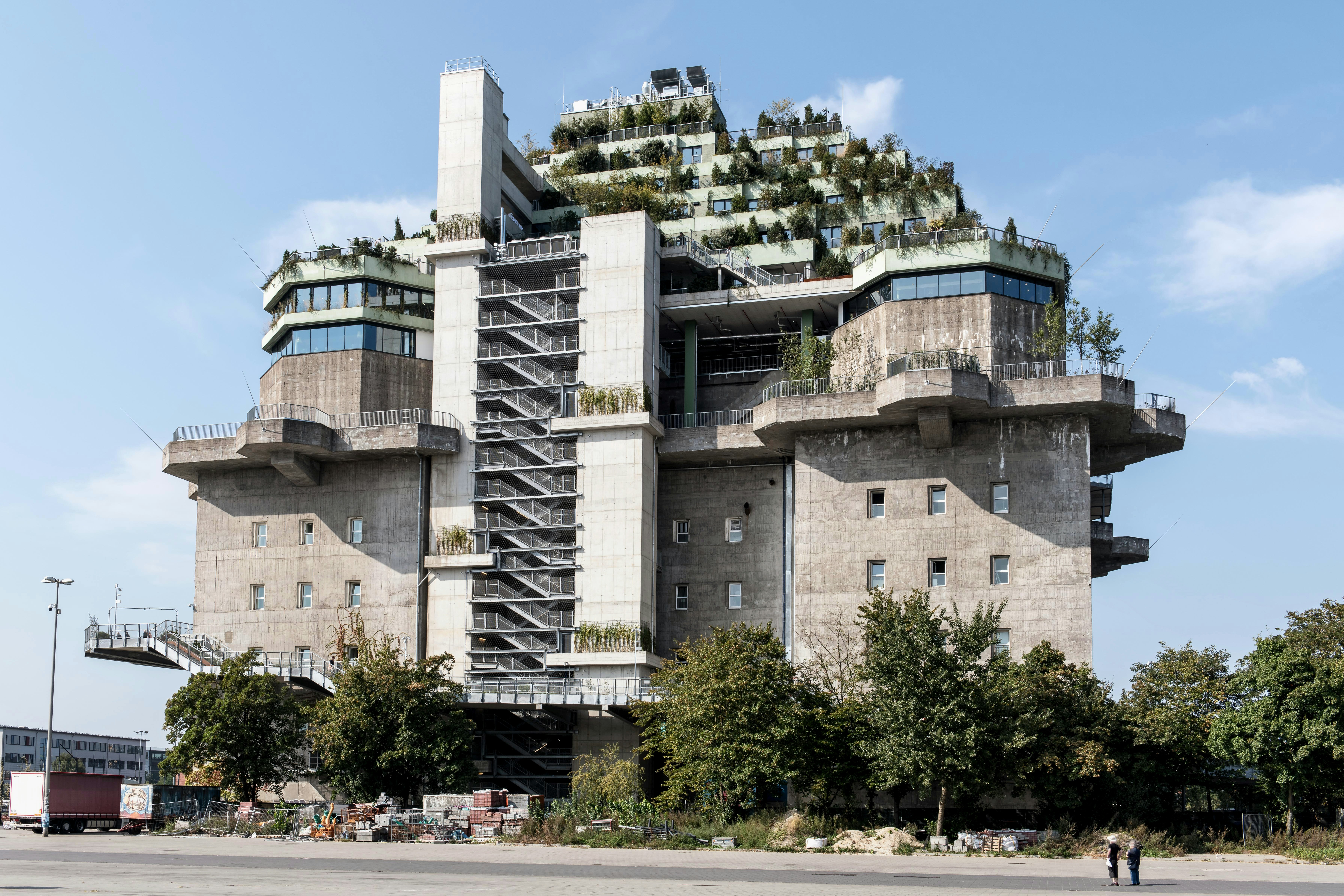 A tall building with a spiral staircase going up the side of it