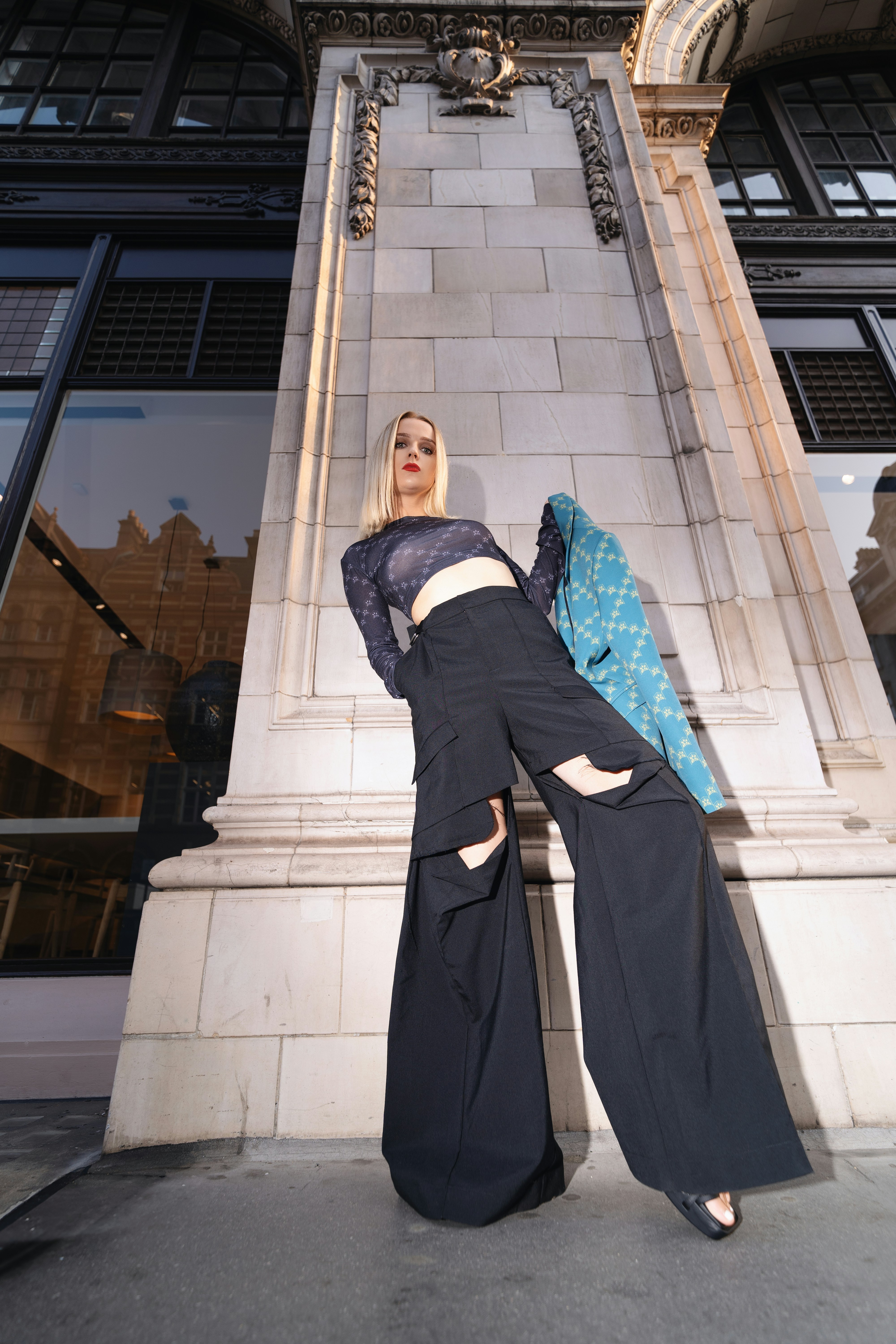 A woman standing in front of a tall building
