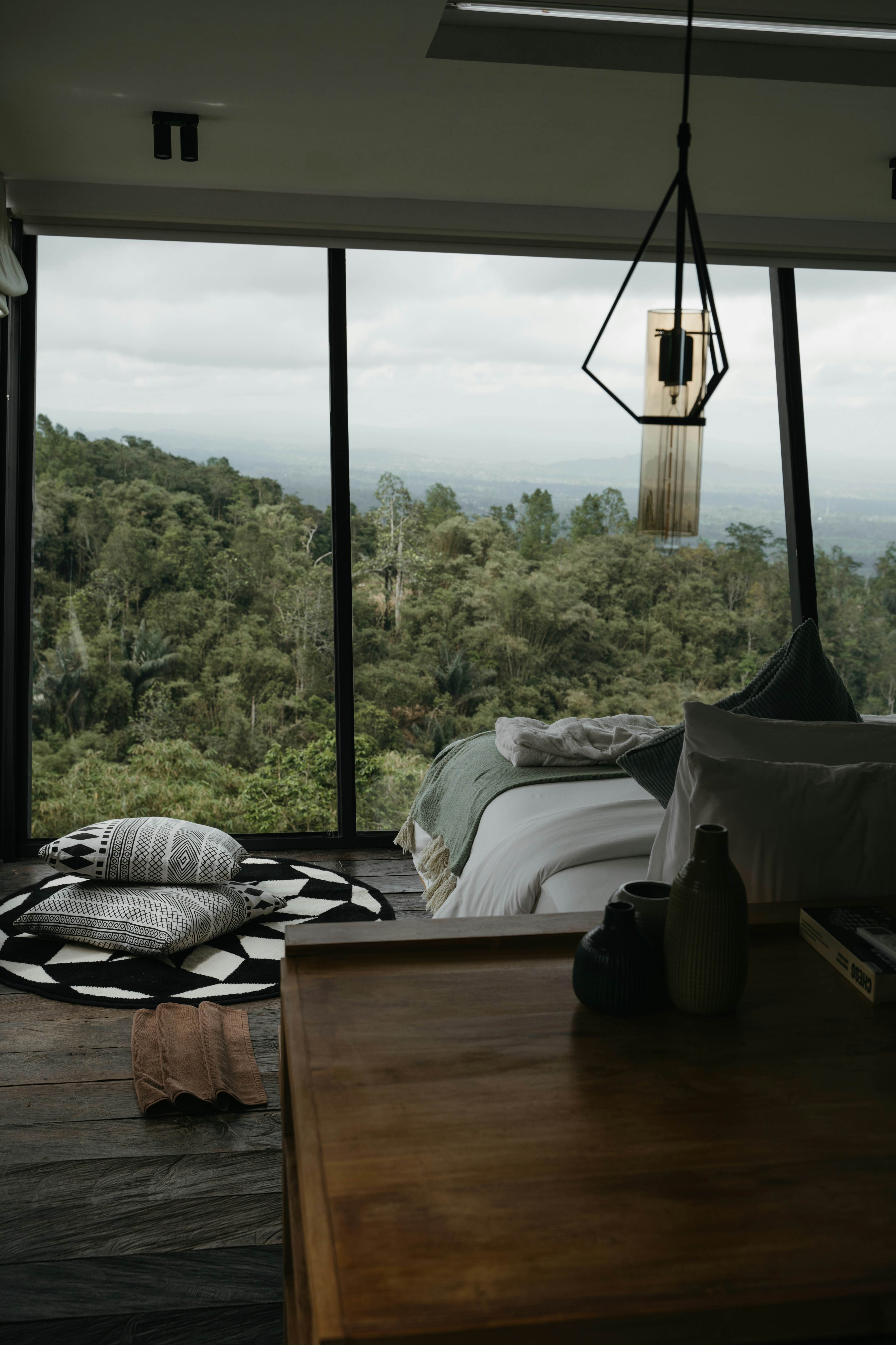 A bedroom with a view of the forest