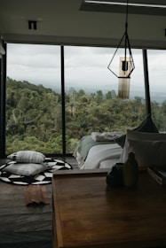 A bedroom with a view of the forest