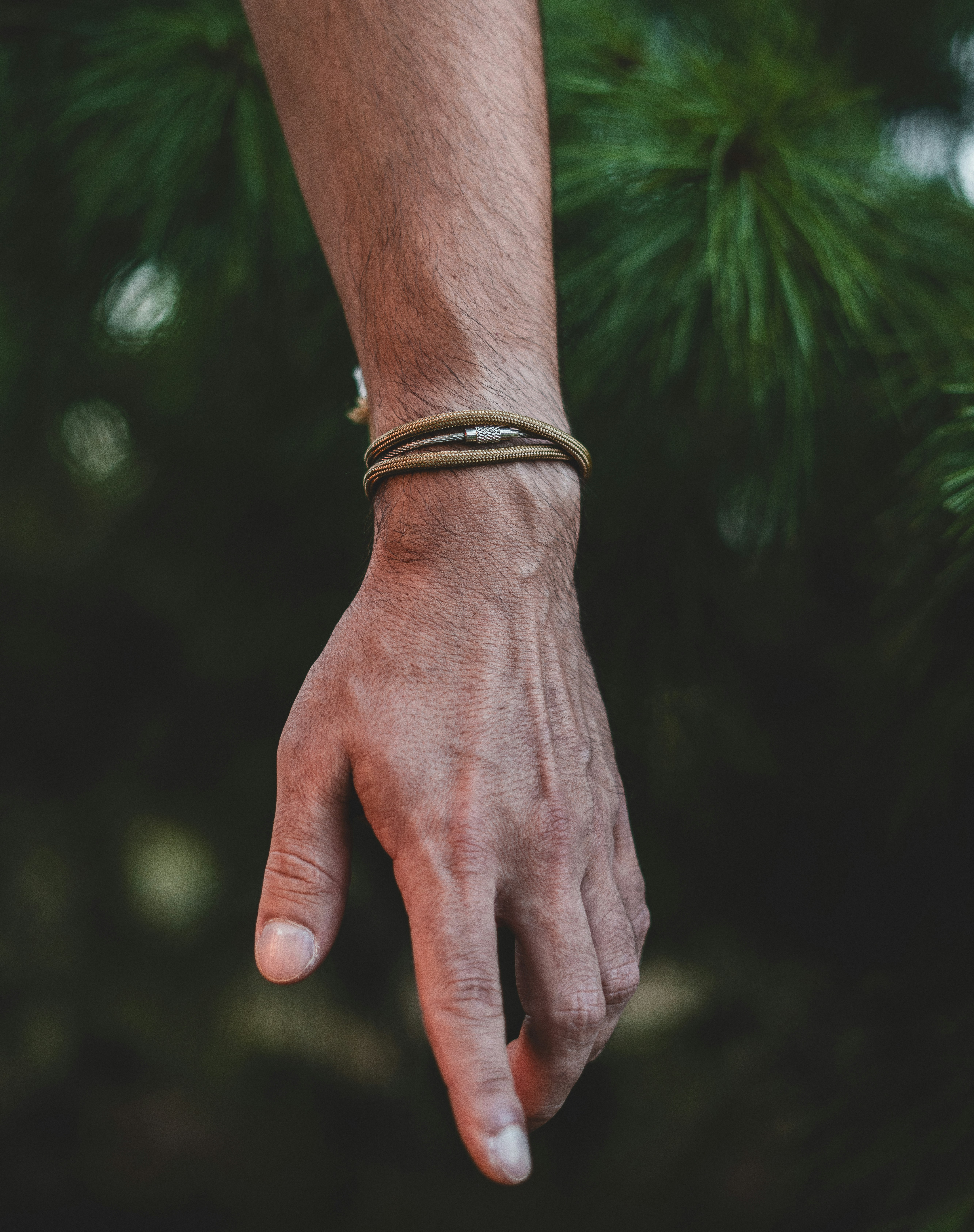 A person's hand with a bracelet on it