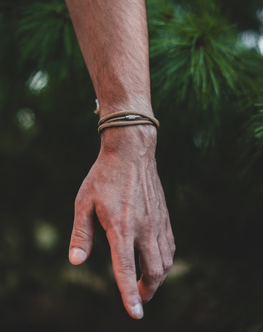 A person's hand with a bracelet on it