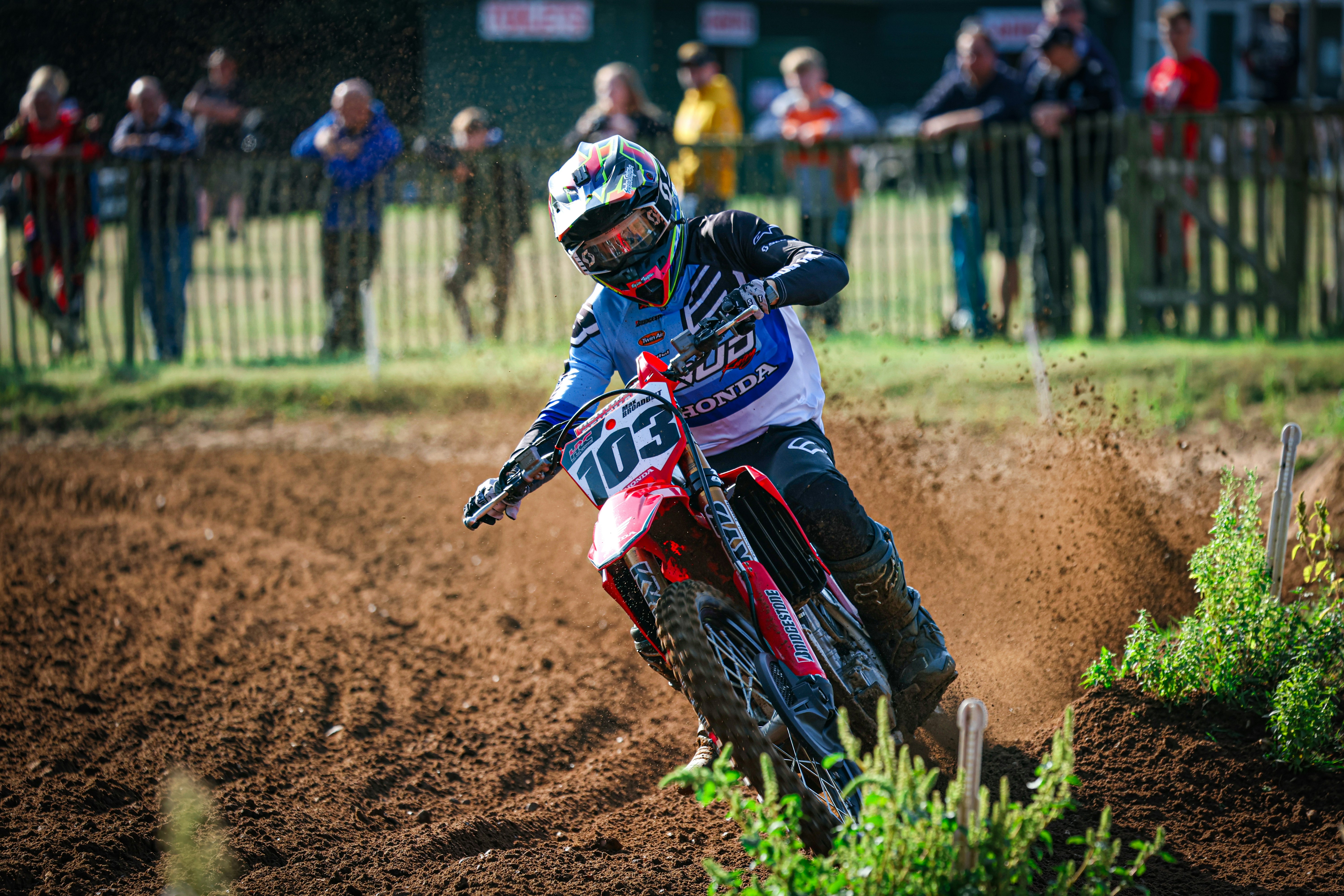 A person riding a dirt bike on a dirt track