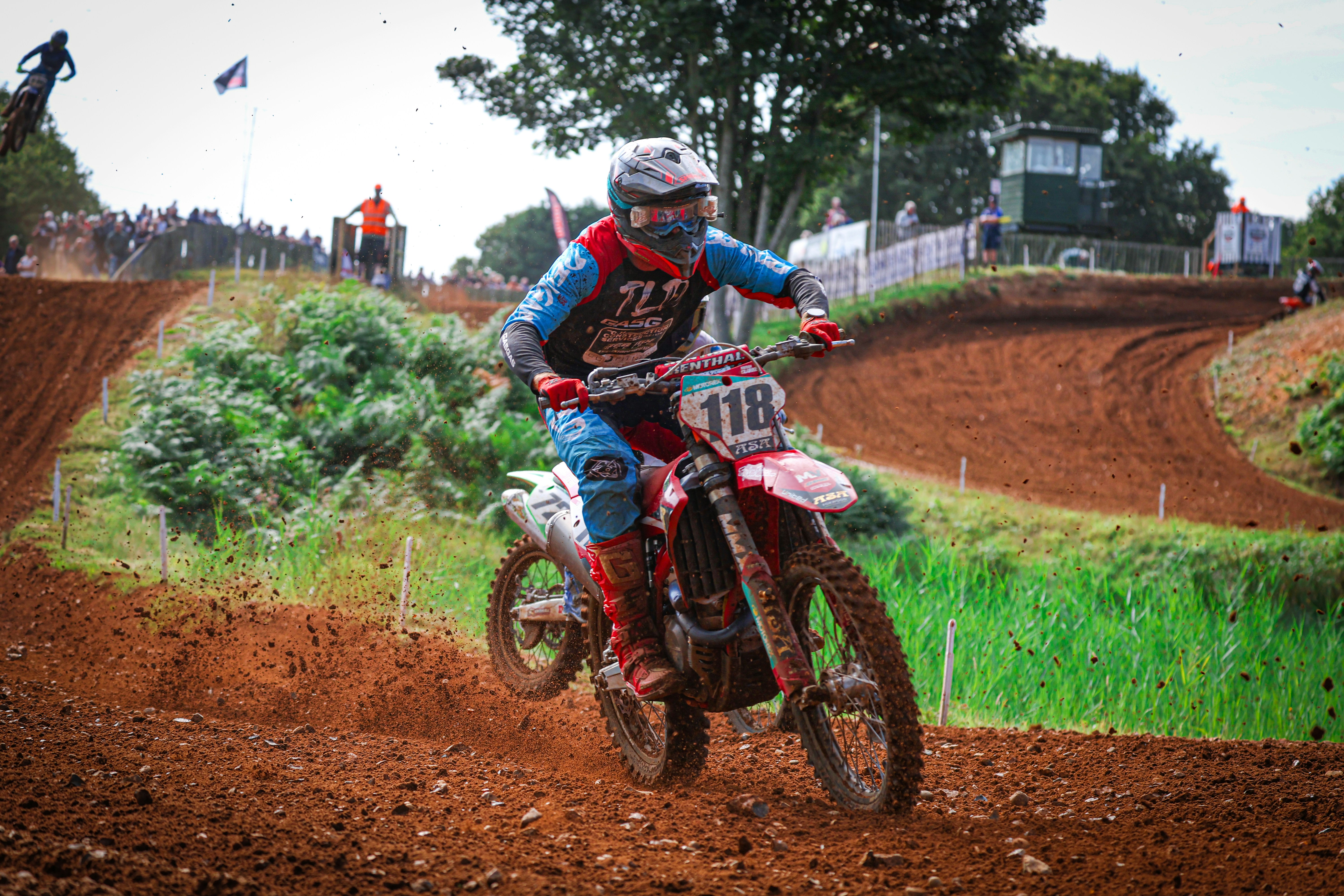 A man riding a dirt bike on top of a dirt field