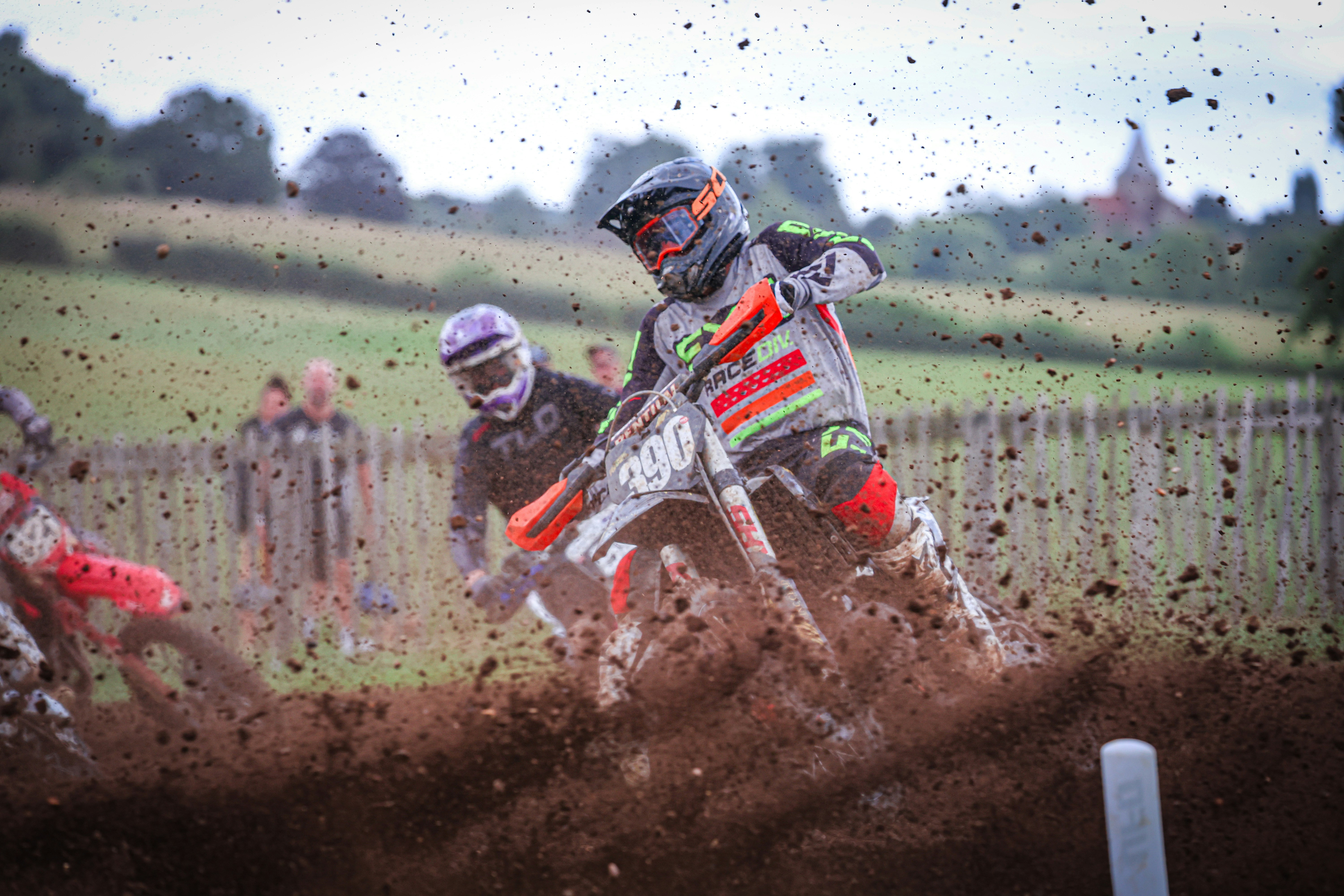 A man riding a dirt bike on top of a dirt field
