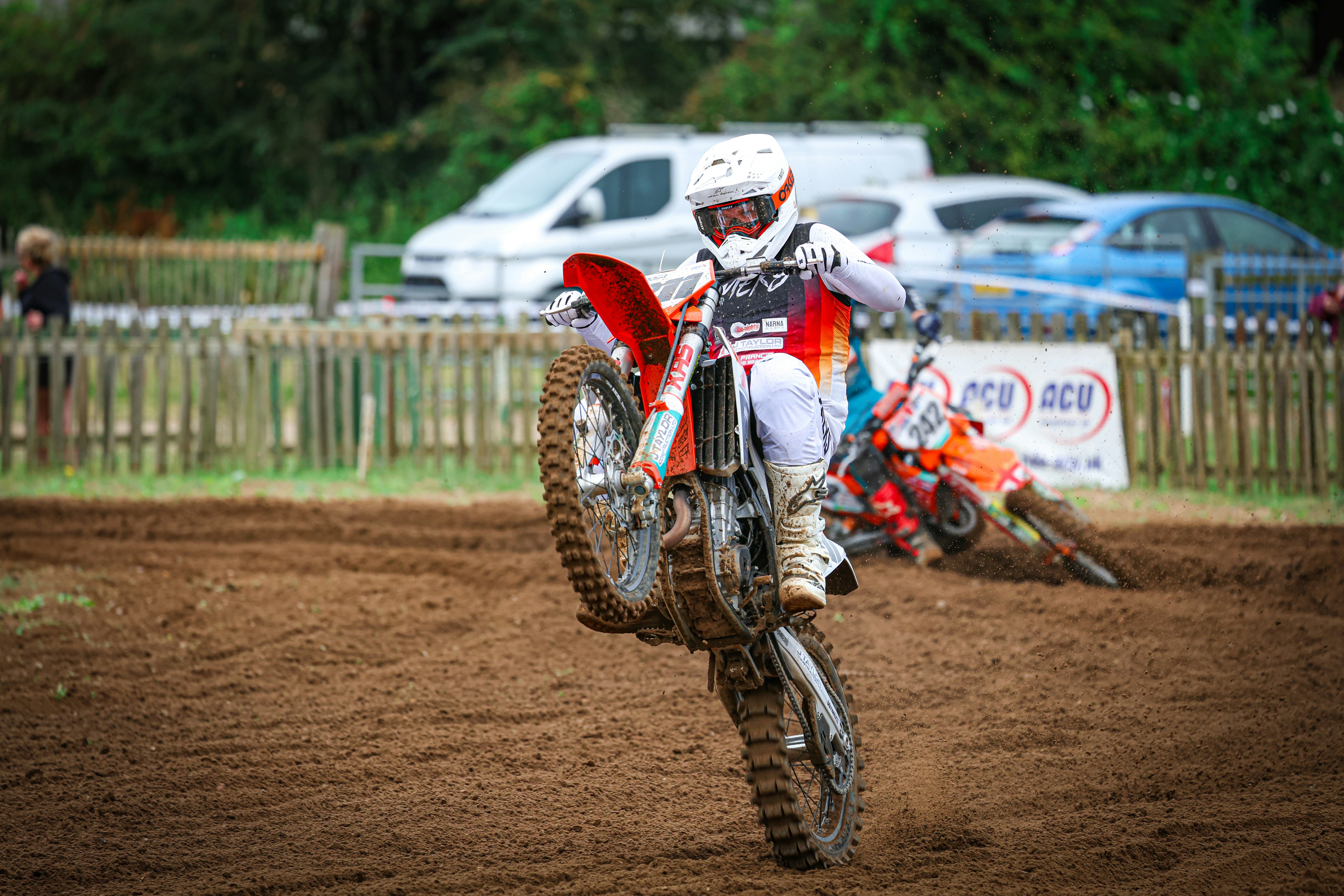 A man riding a dirt bike on top of a dirt field
