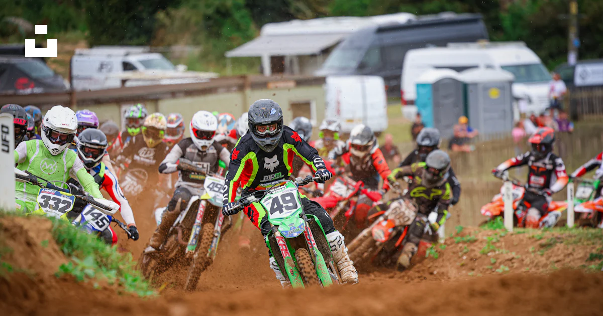 A group of people riding dirt bikes on a dirt track photo – Free ...