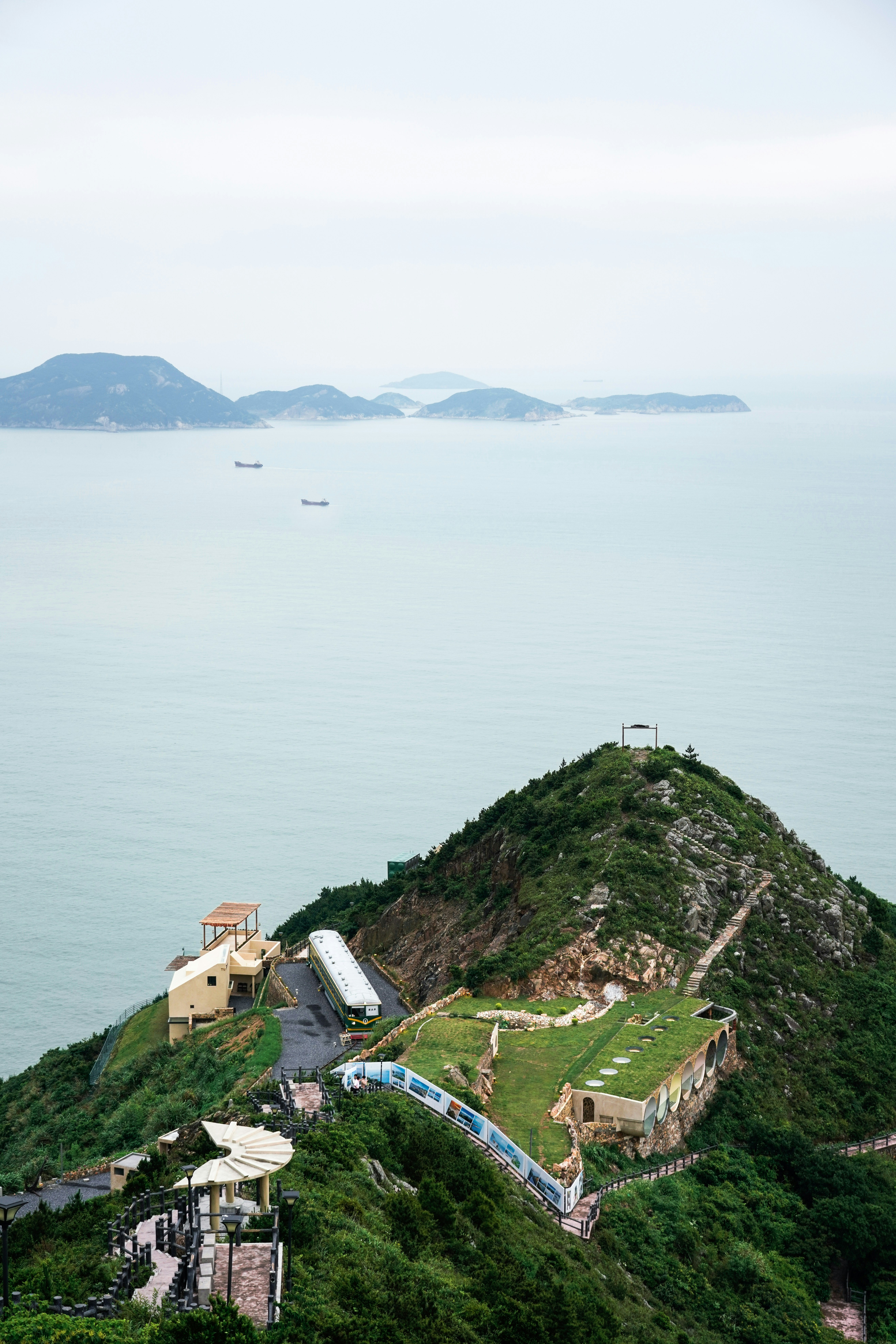 A hill with a large body of water in the background