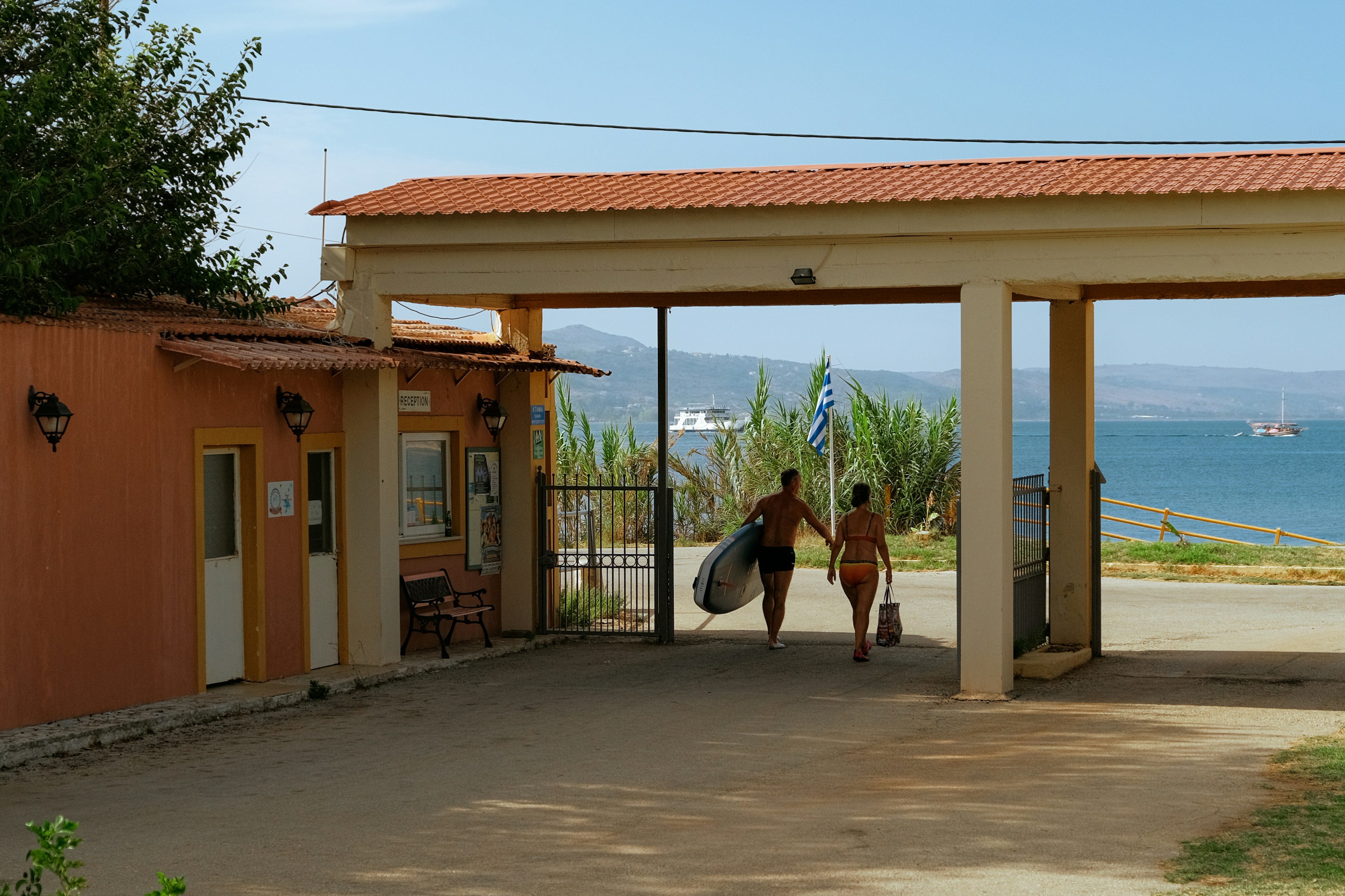 A couple of people that are walking towards a building
