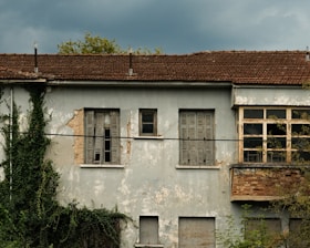 An old run down building with a broken window