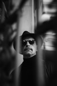 A man with a hat and sunglasses on