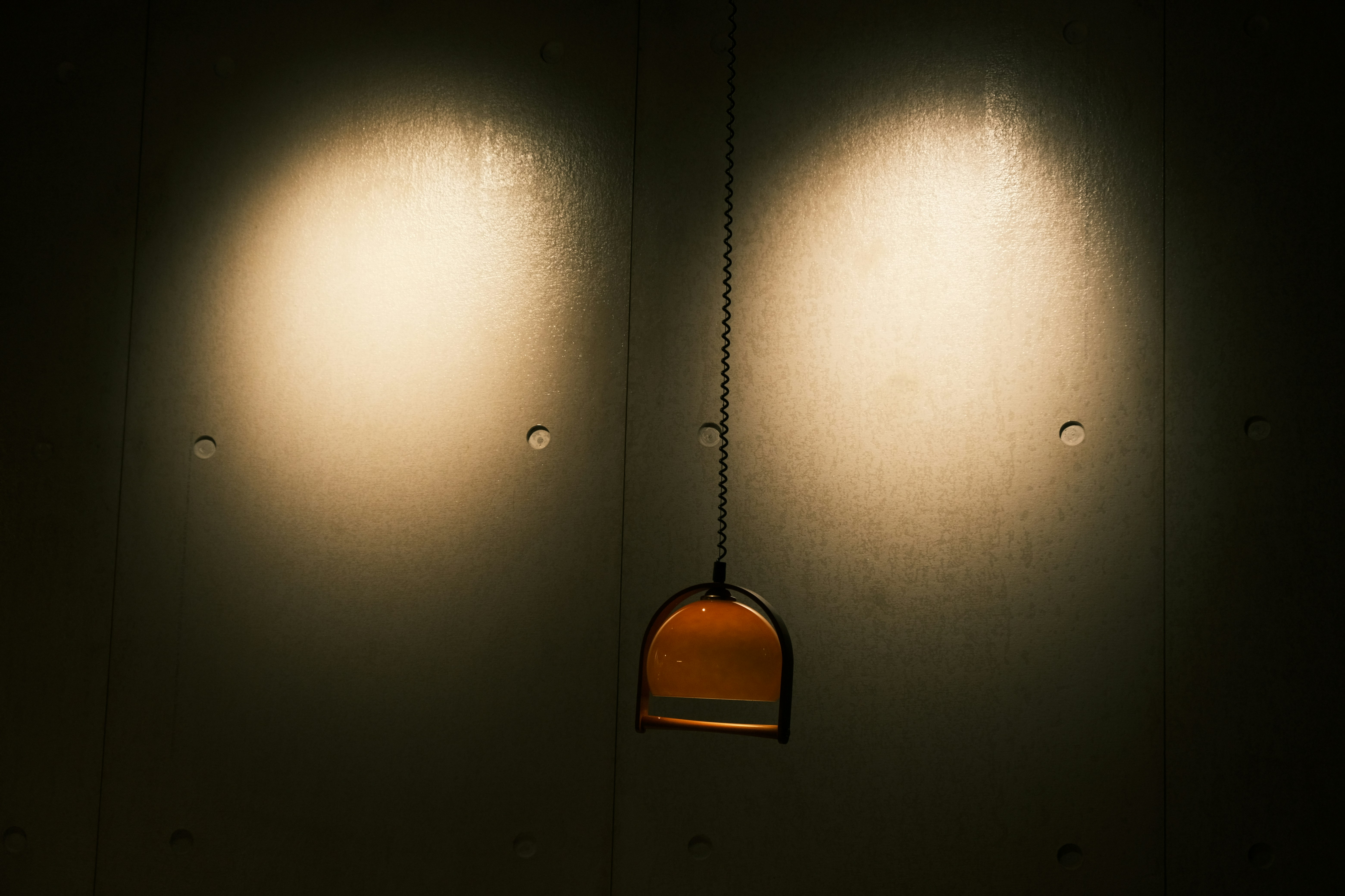 A room with three lights on the wall